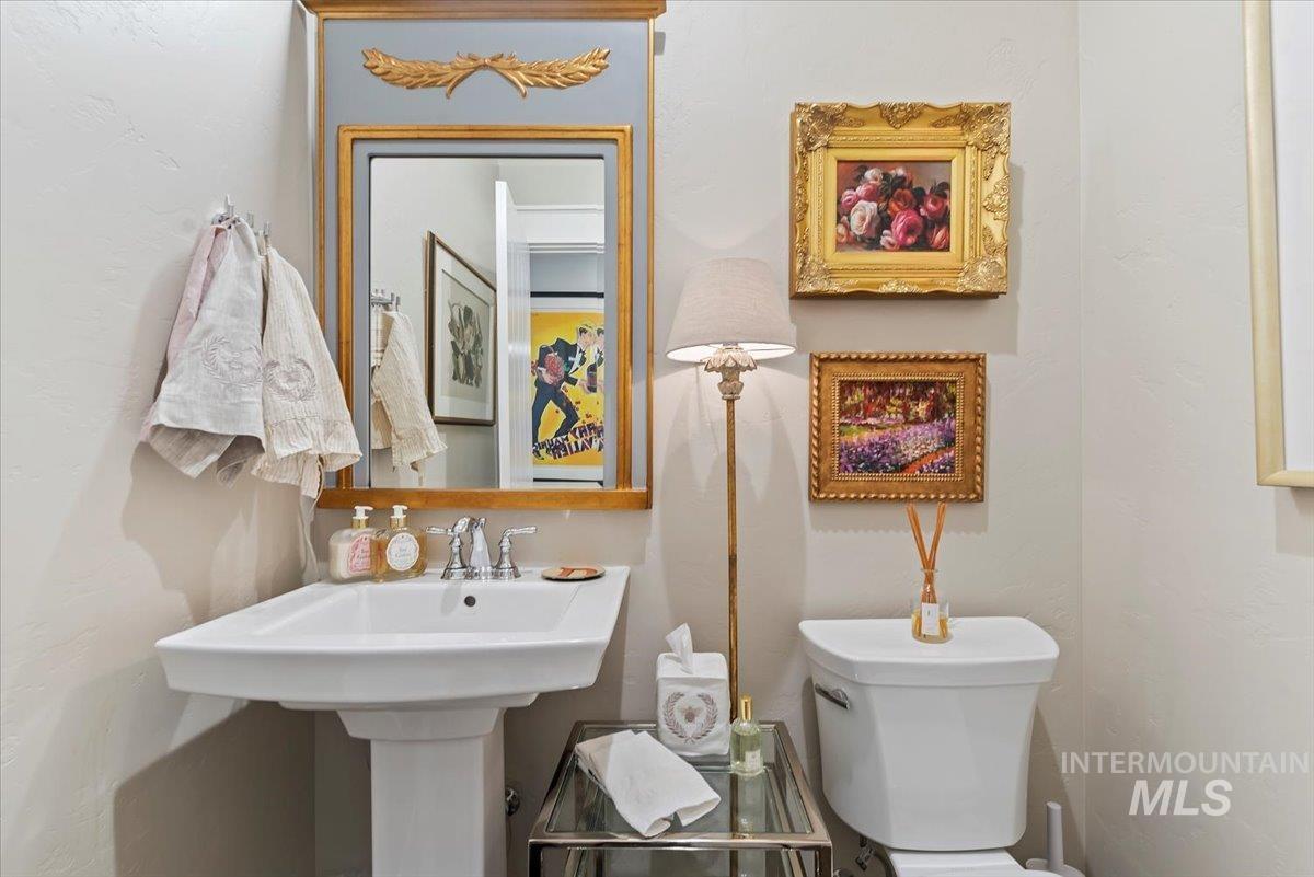 Bathroom featuring toilet and a textured wall