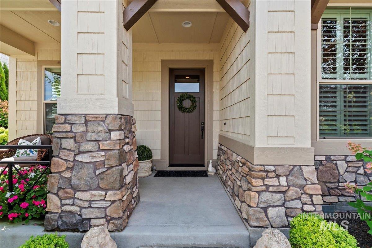Property entrance featuring stone siding