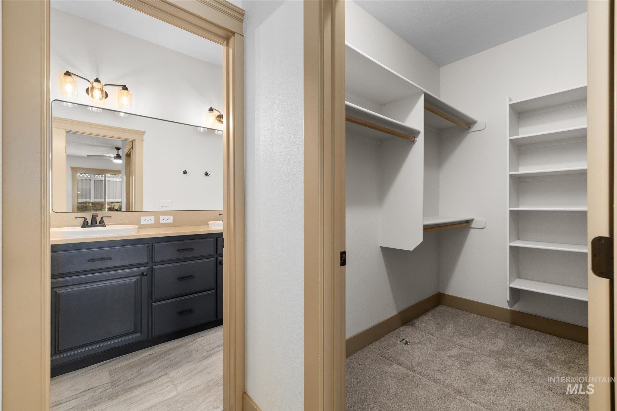 Spacious closet featuring a sink and ceiling fan