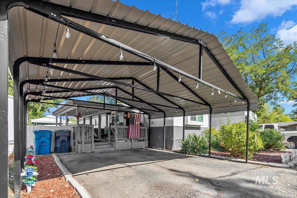 View of parking / parking lot with a detached carport