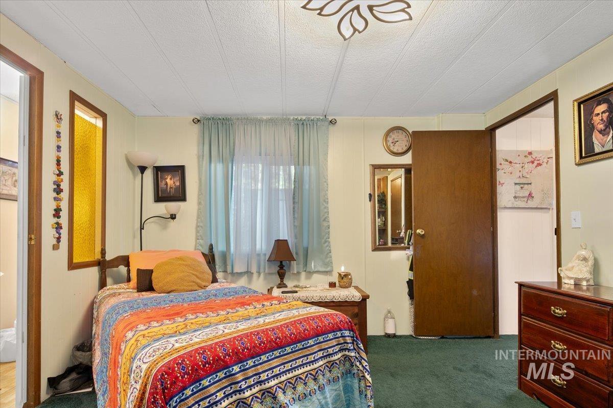 Carpeted bedroom featuring a textured ceiling