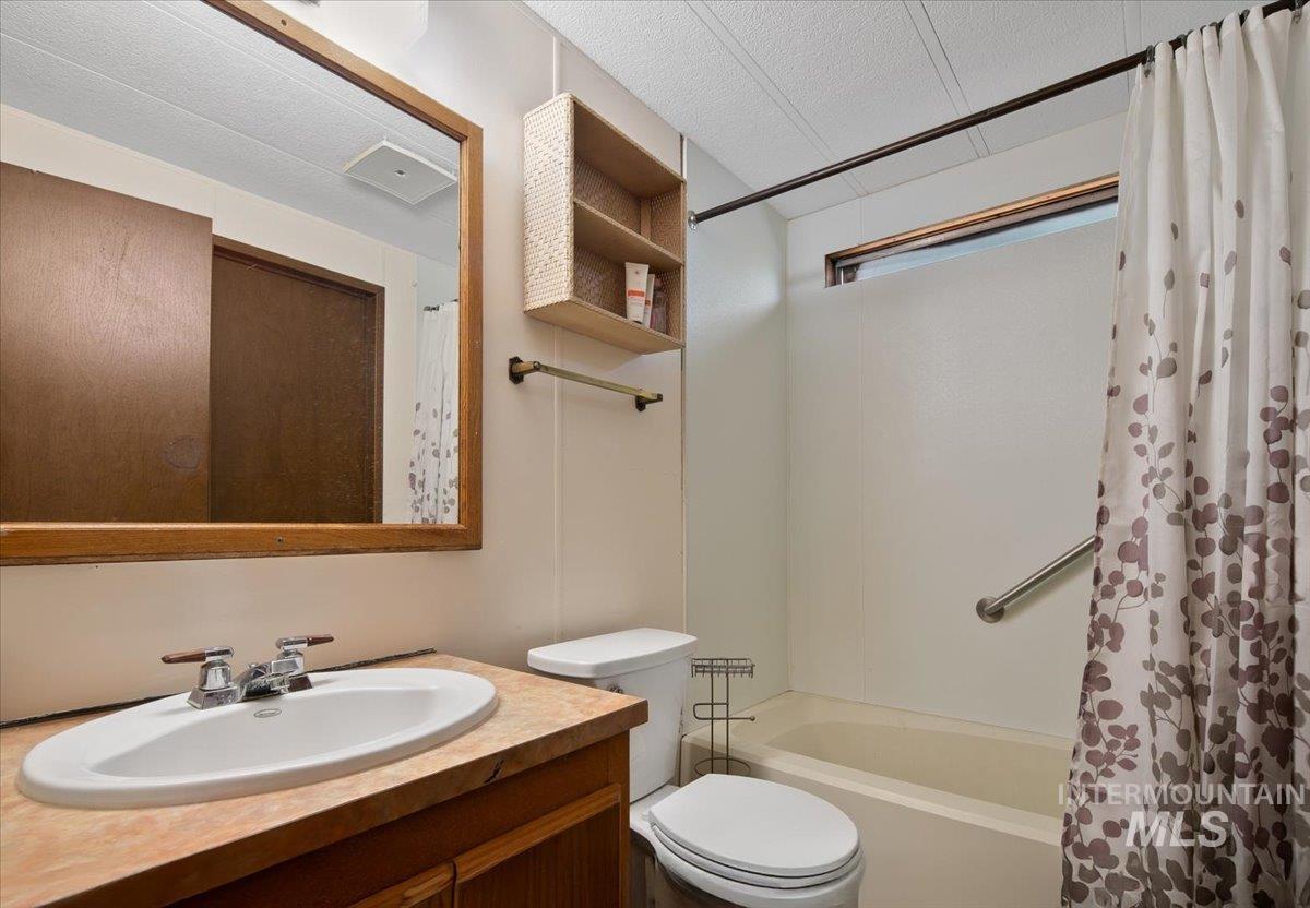 Bathroom with shower / bath combo and vanity