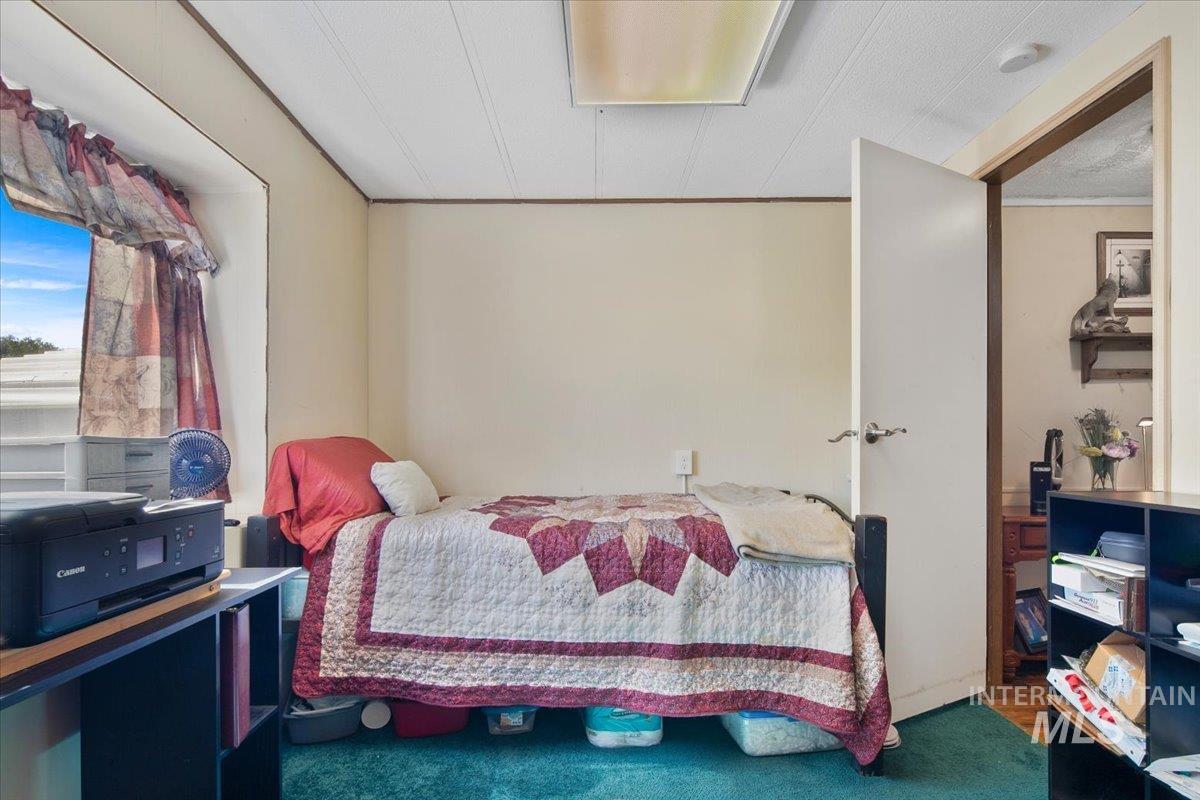 Bedroom featuring carpet flooring and crown molding