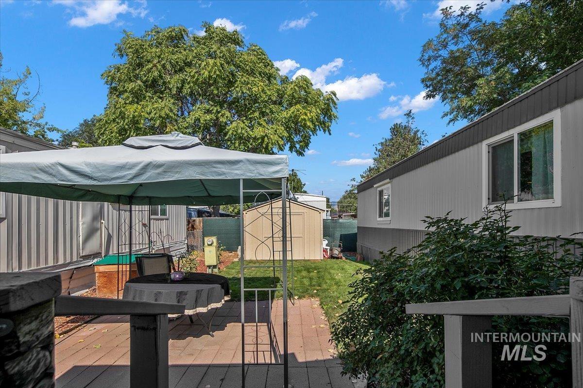 Deck featuring a shed and outdoor dining space