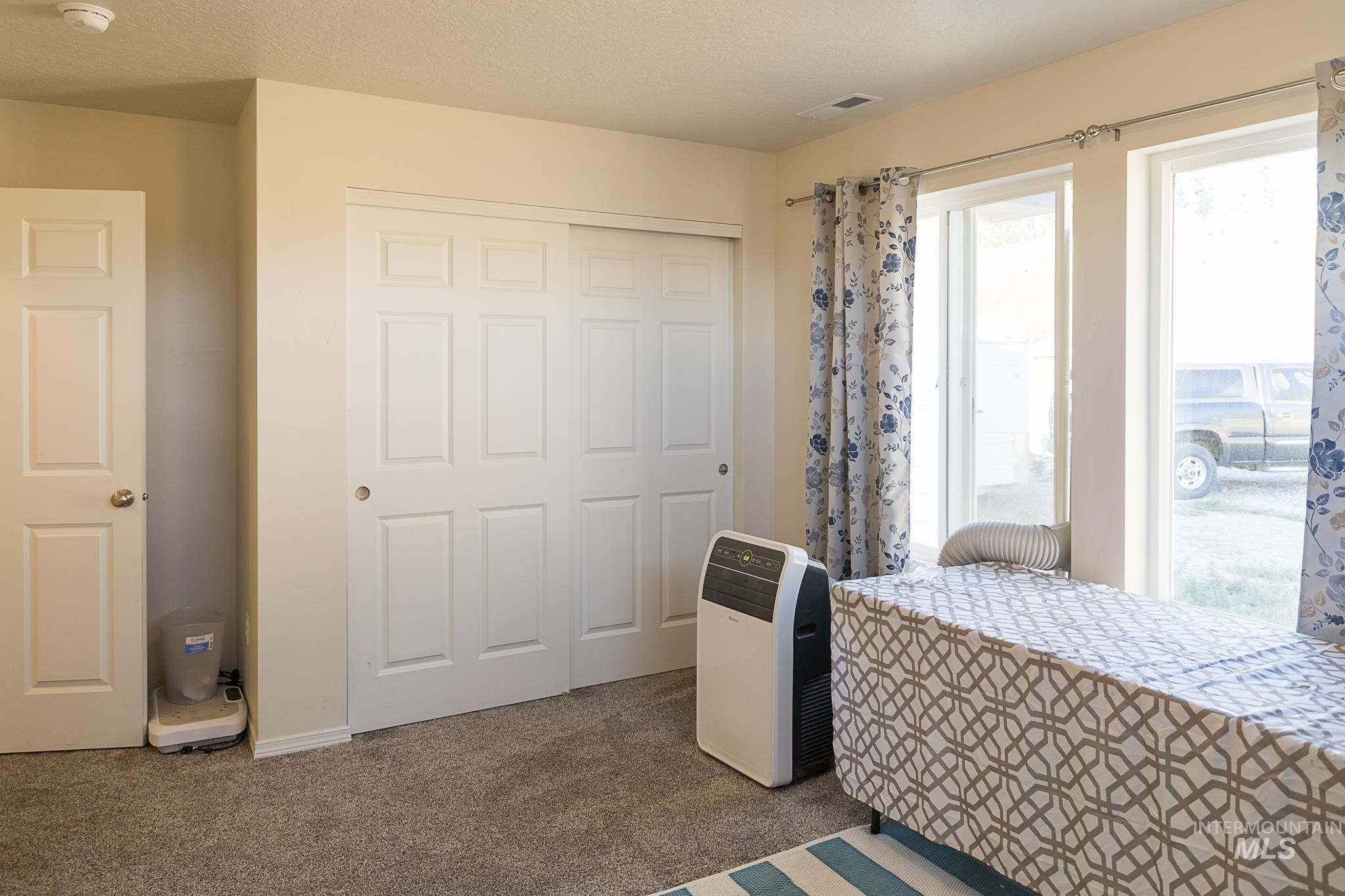 Bedroom with carpet flooring and a closet