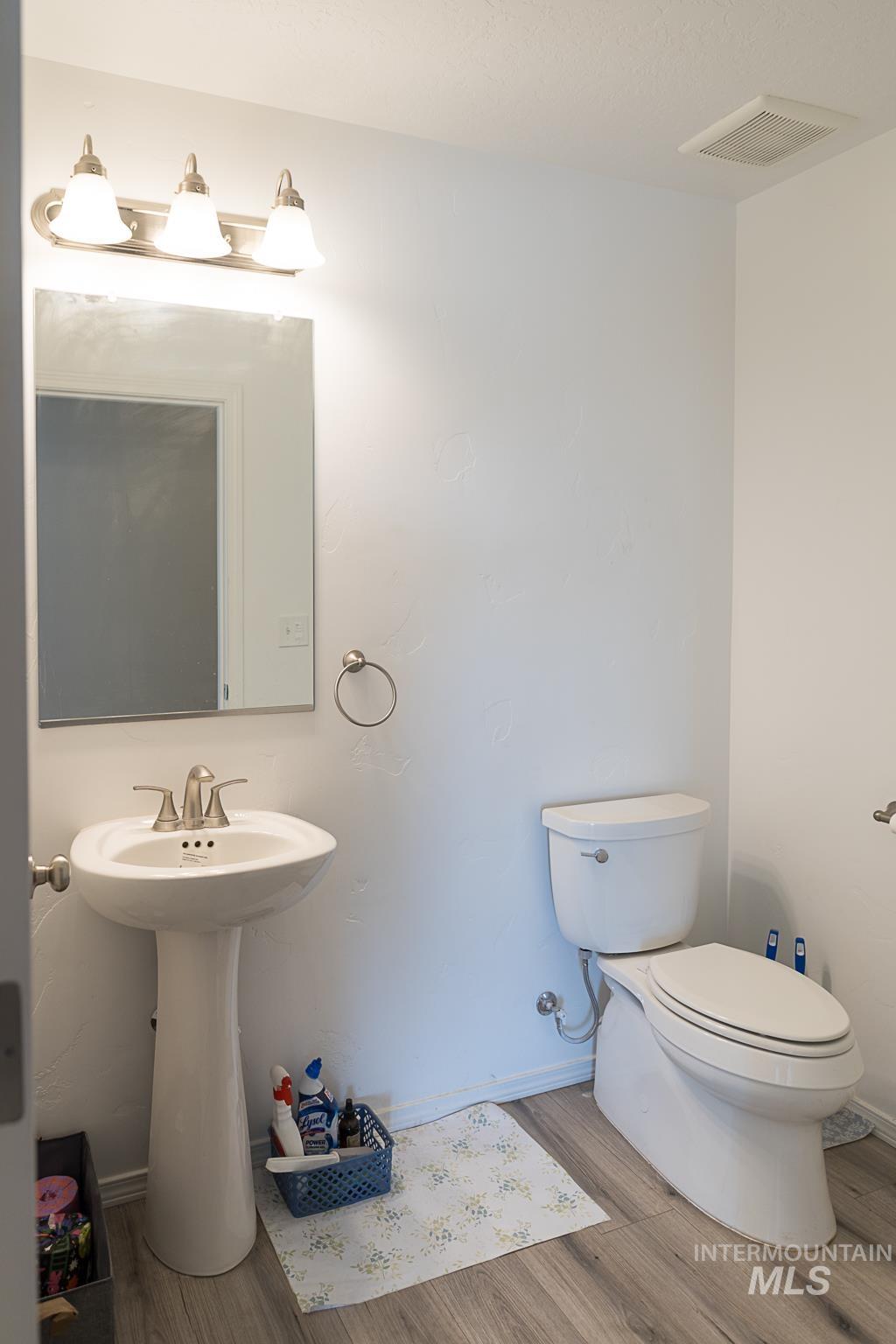 Half bathroom featuring wood finished floors