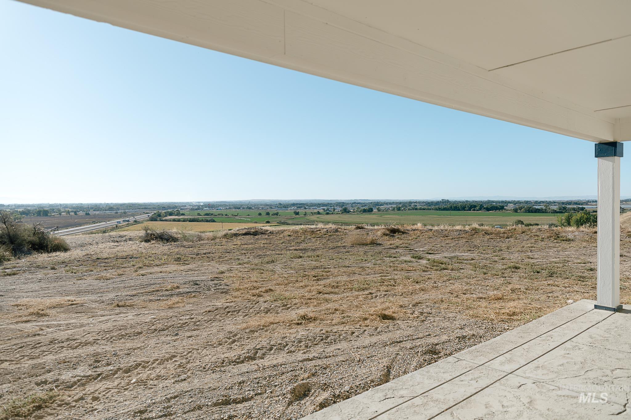 View of yard with a rural view