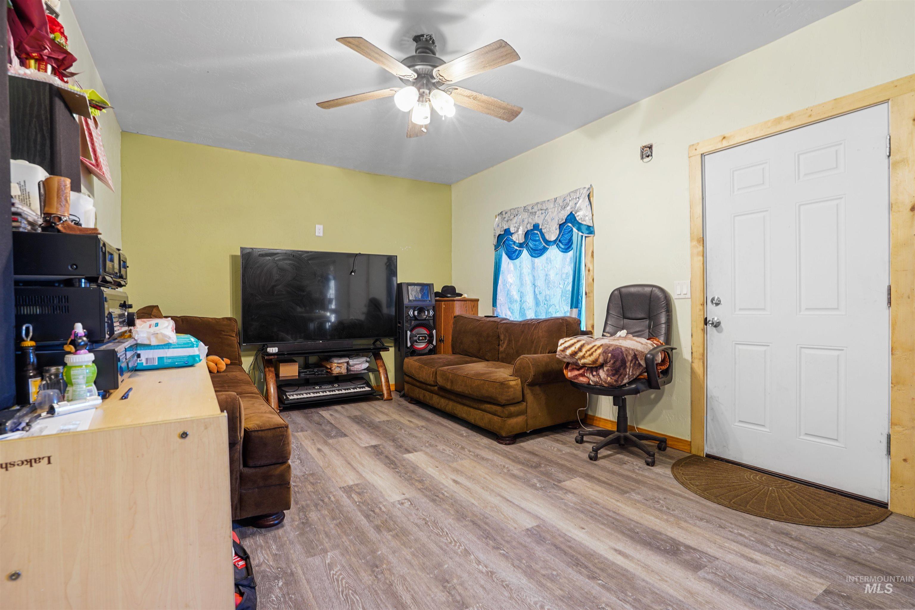 Living room featuring light wood-style floors and ceiling fan