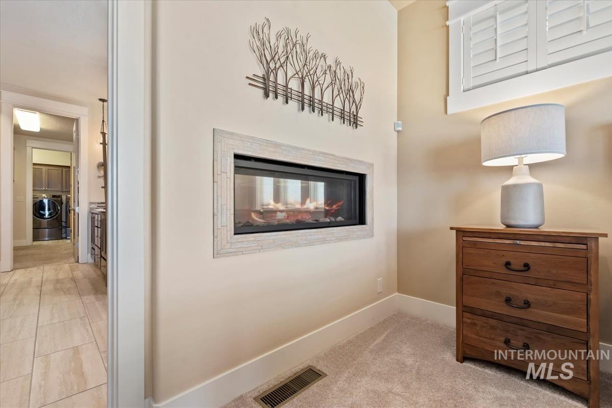 Gas fireplace shared by primary bedroom and primary bathroom.