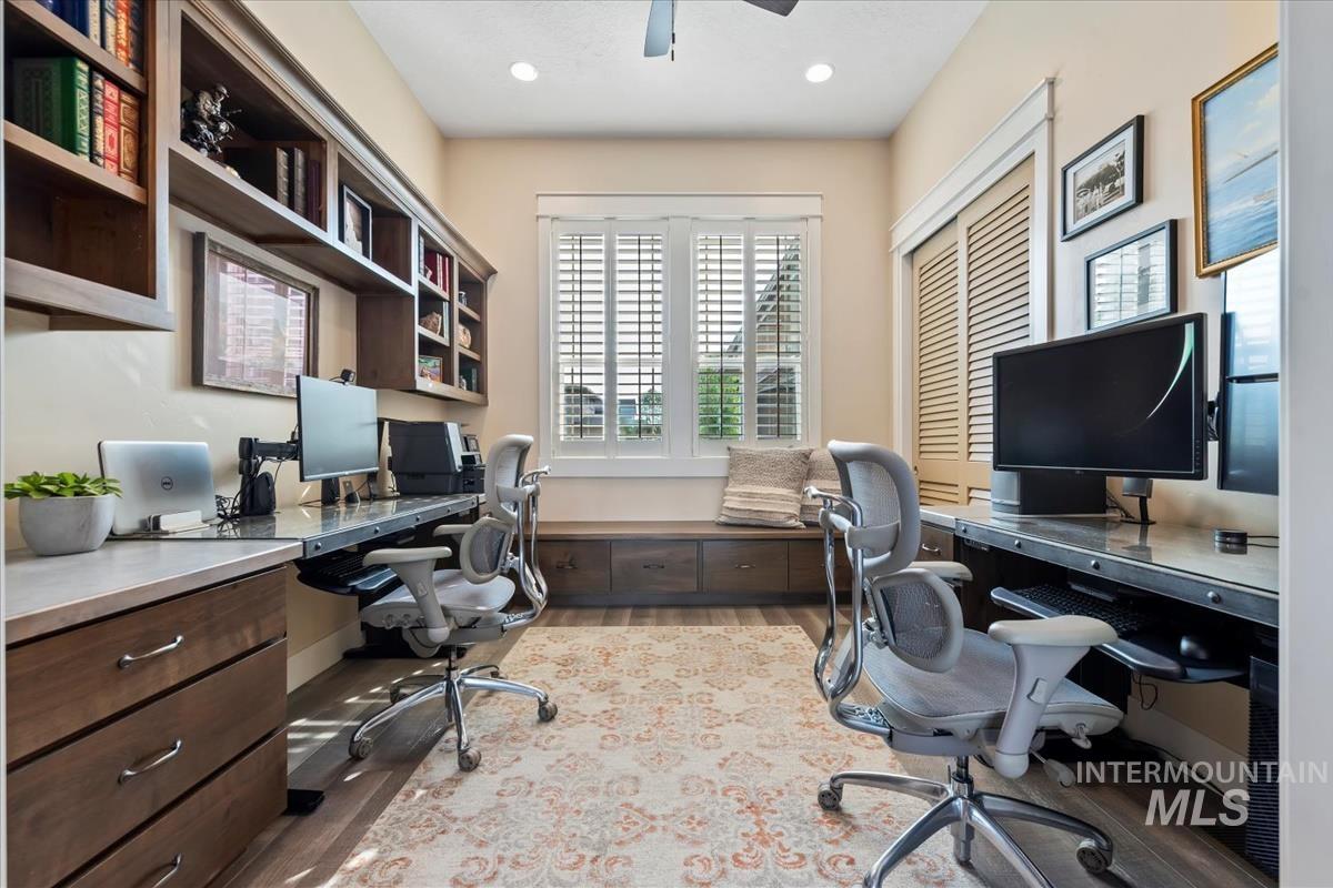 Office area with built in study area, light wood-style flooring, a ceiling fan, and recessed lighting