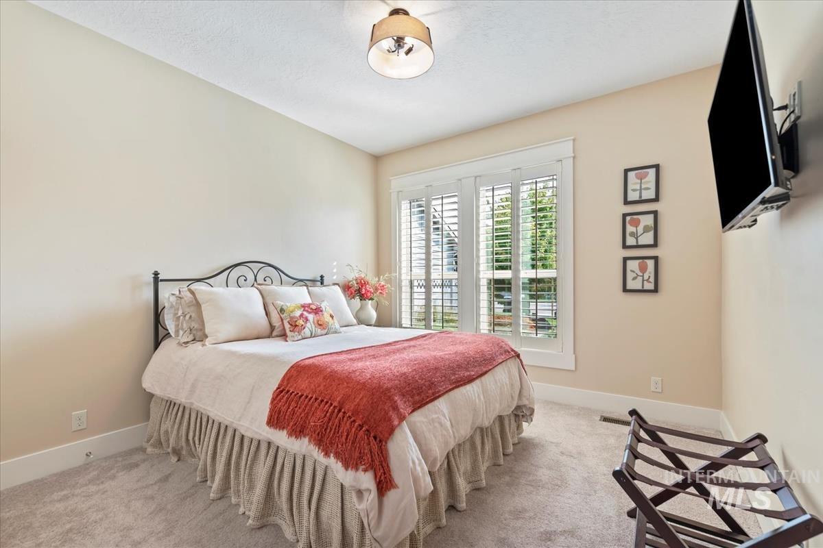 Bedroom featuring carpet and baseboards
