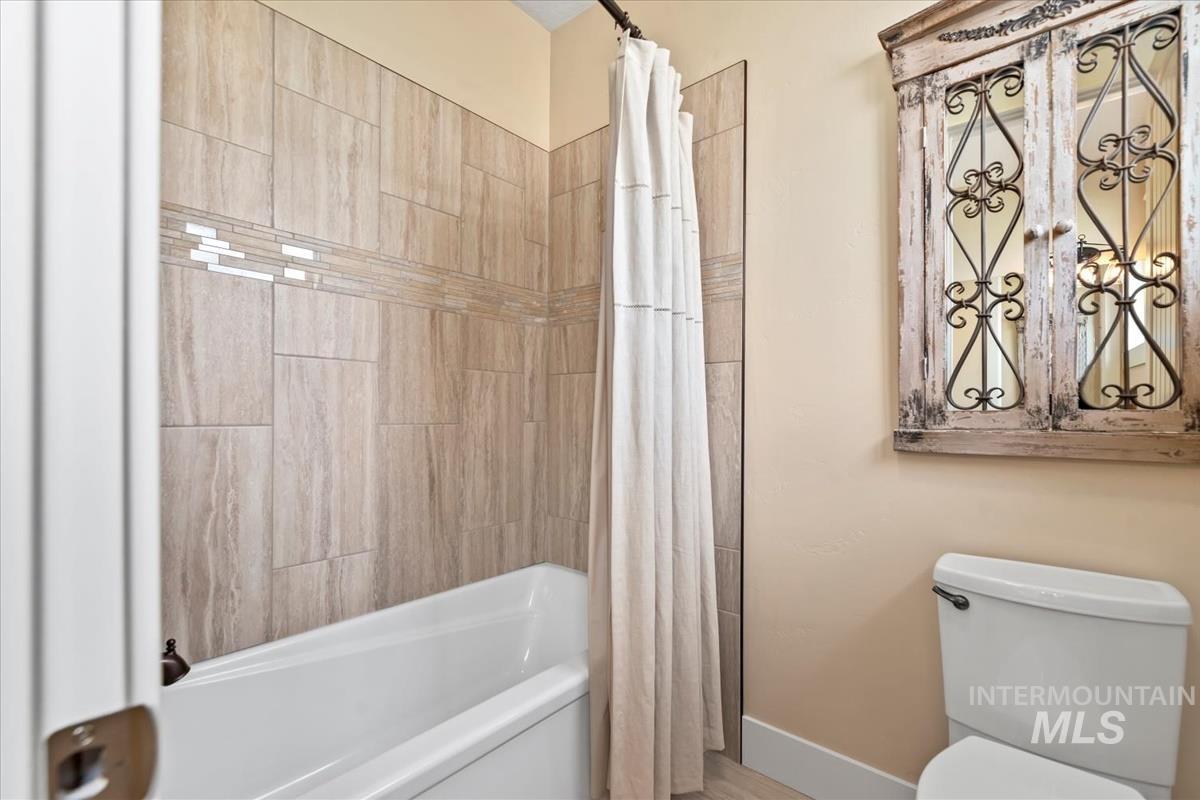 Bathroom with shower / bath combo and toilet
