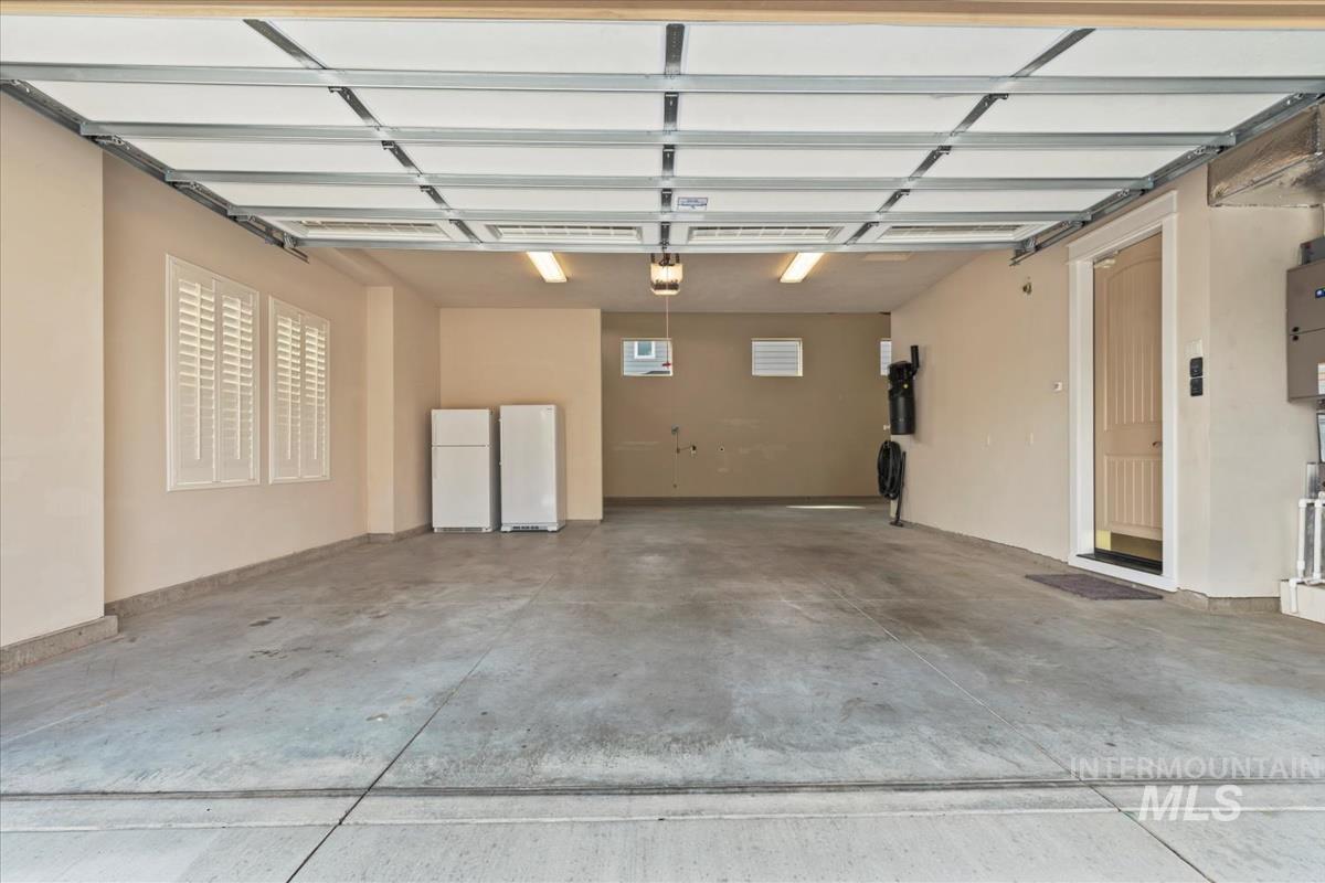 Garage featuring freestanding refrigerator