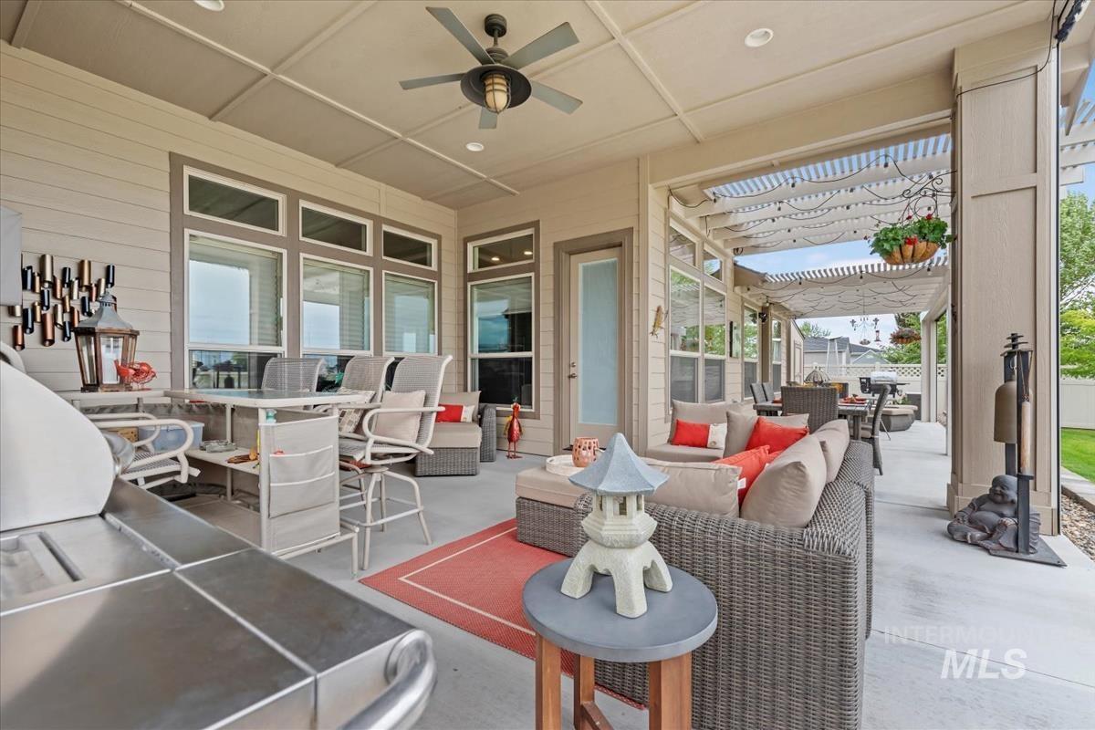 View of patio with an outdoor hangout area, outdoor dining area, and ceiling fan