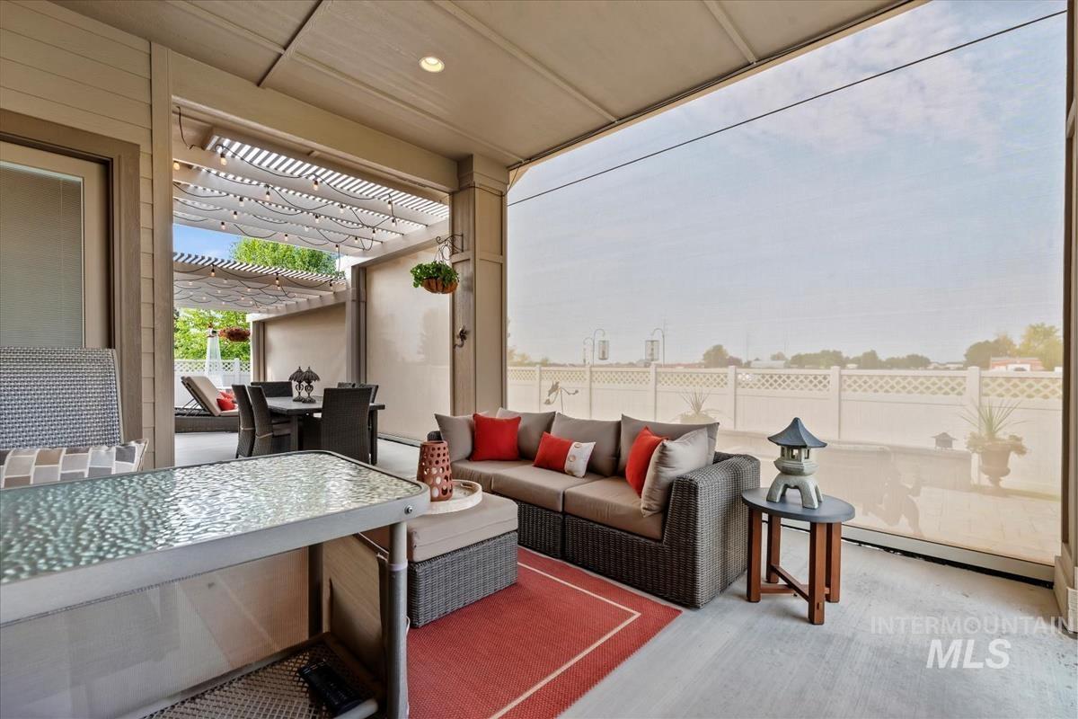 View of patio with a pergola, an outdoor hangout area, outdoor dining space, and baseboard heating