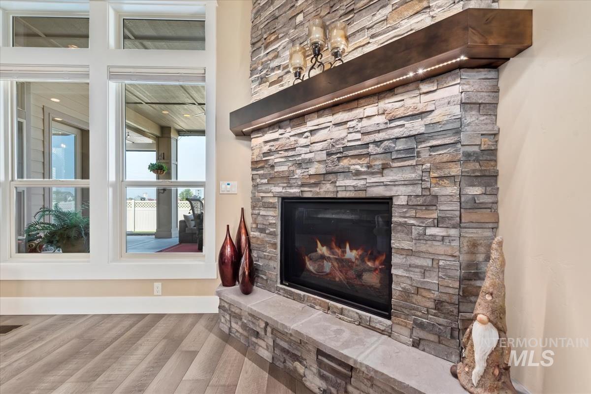 Detailed view of a fireplace and wood finished floors