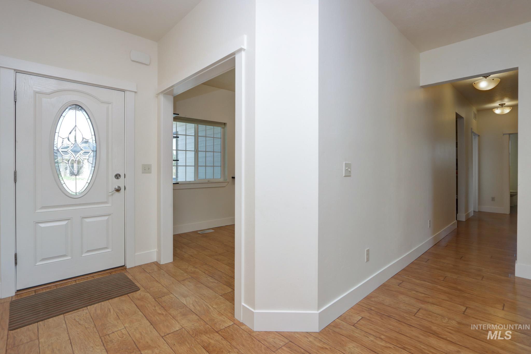 Foyer featuring baseboards and light wood-style flooring