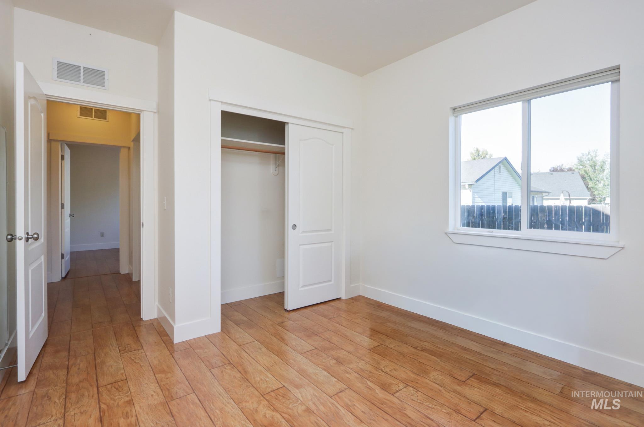 Unfurnished bedroom with a closet and light wood-type flooring