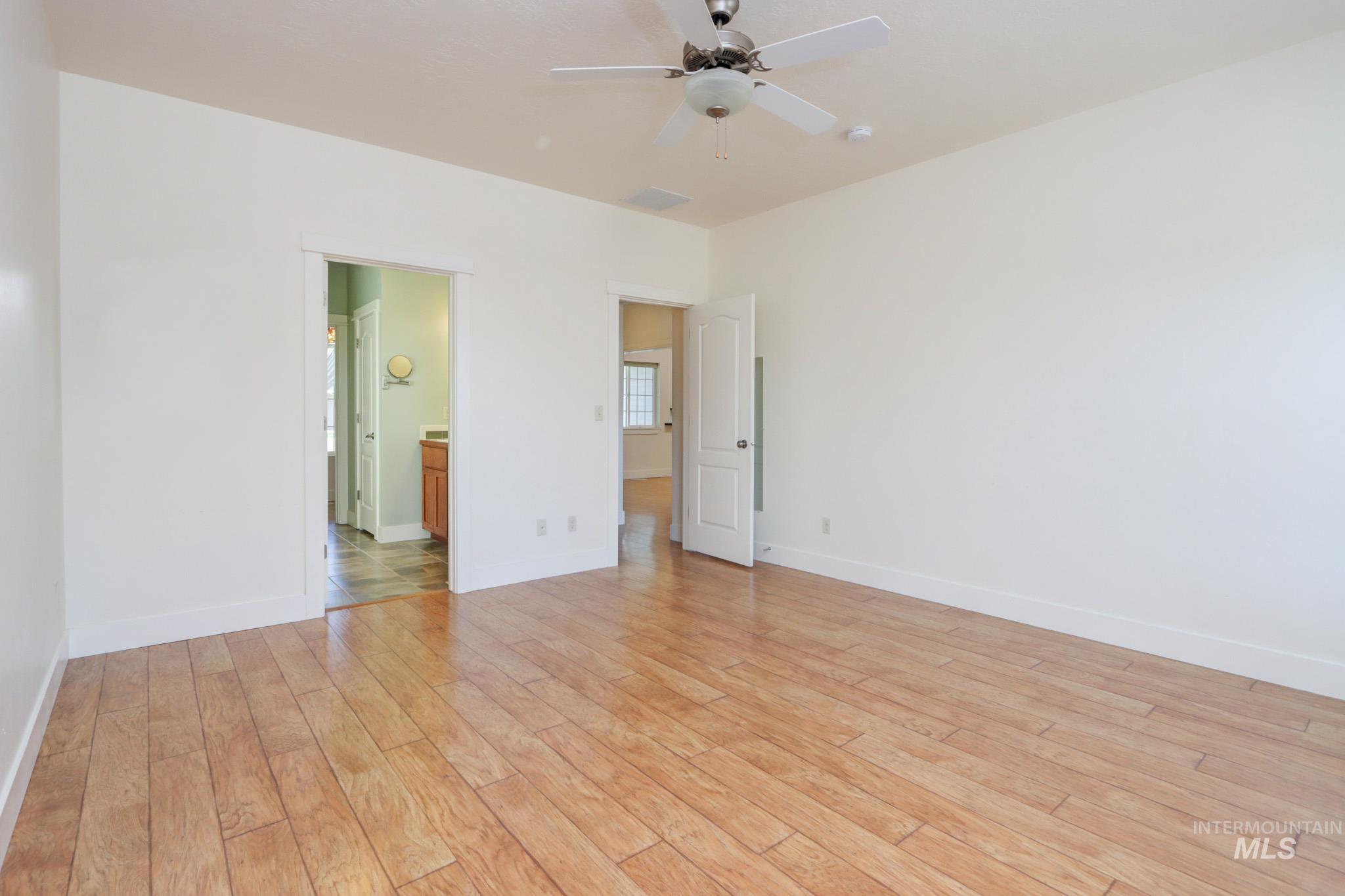Spare room featuring light wood-type flooring and ceiling fan