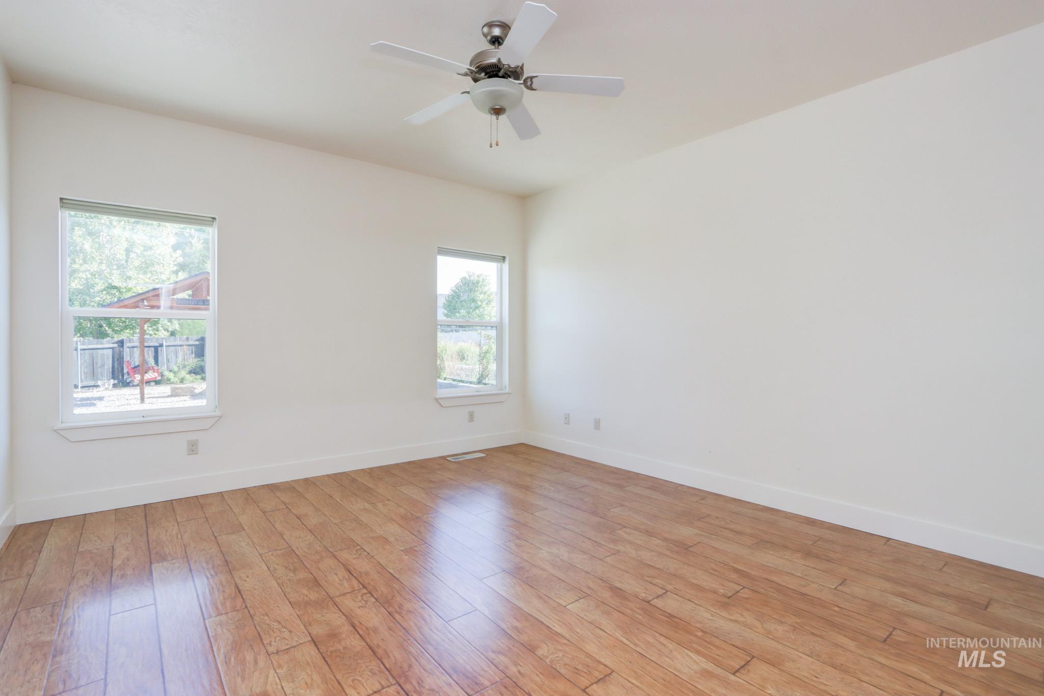 Spare room with light wood-style flooring and a ceiling fan