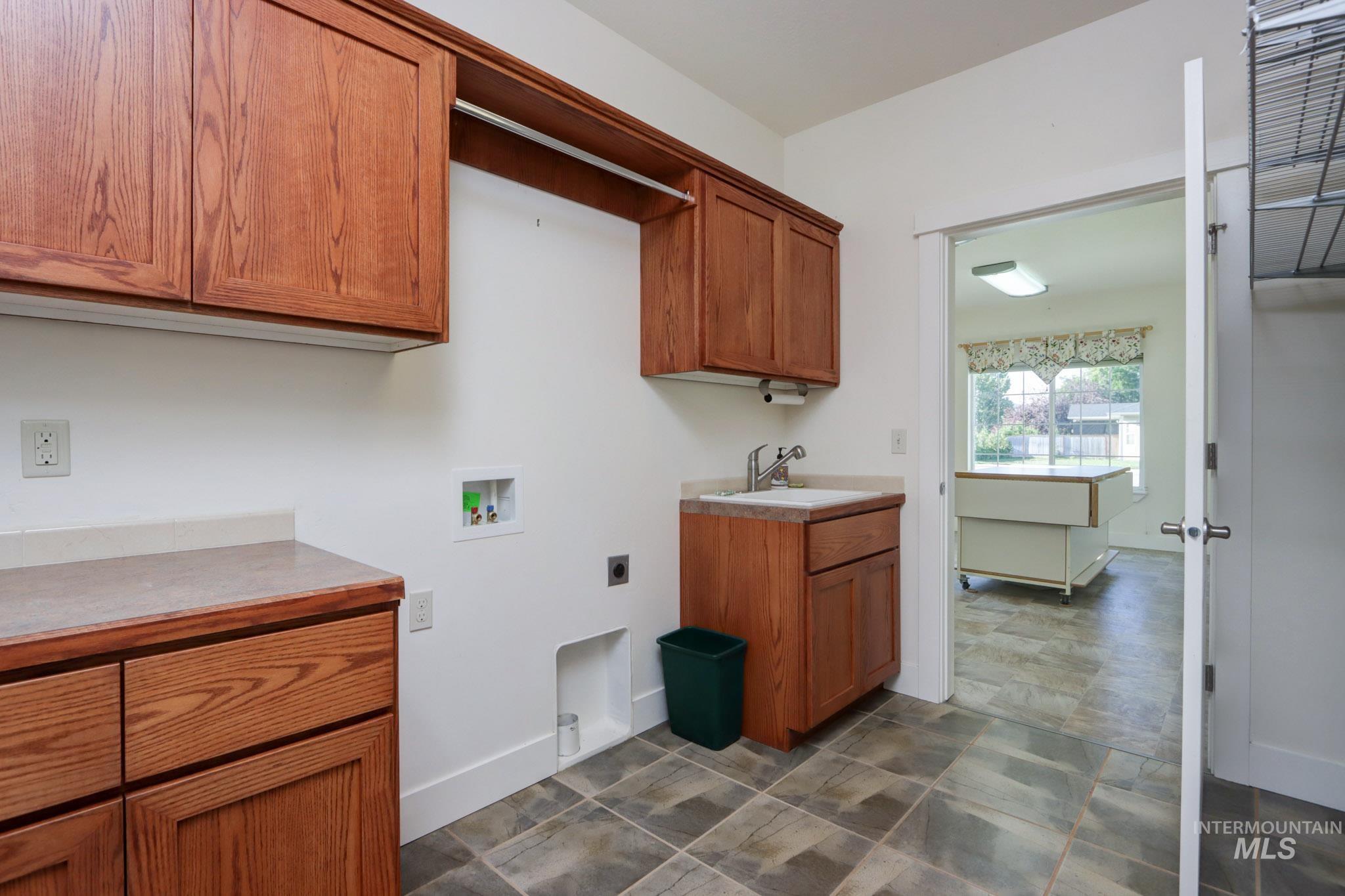 Laundry room featuring hookup for a washing machine, cabinet space, and hookup for an electric dryer