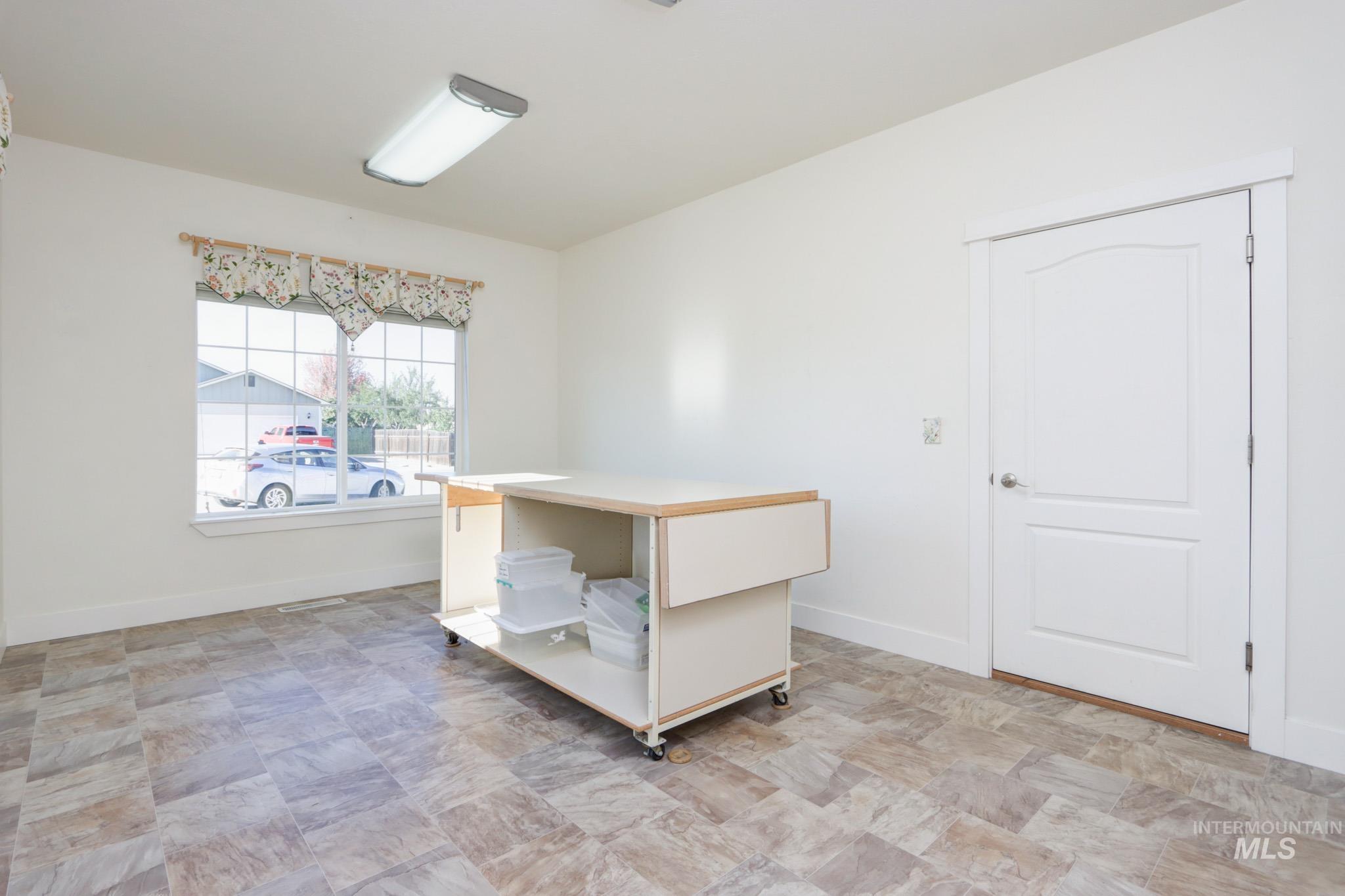 Empty room featuring baseboards and stone finish flooring