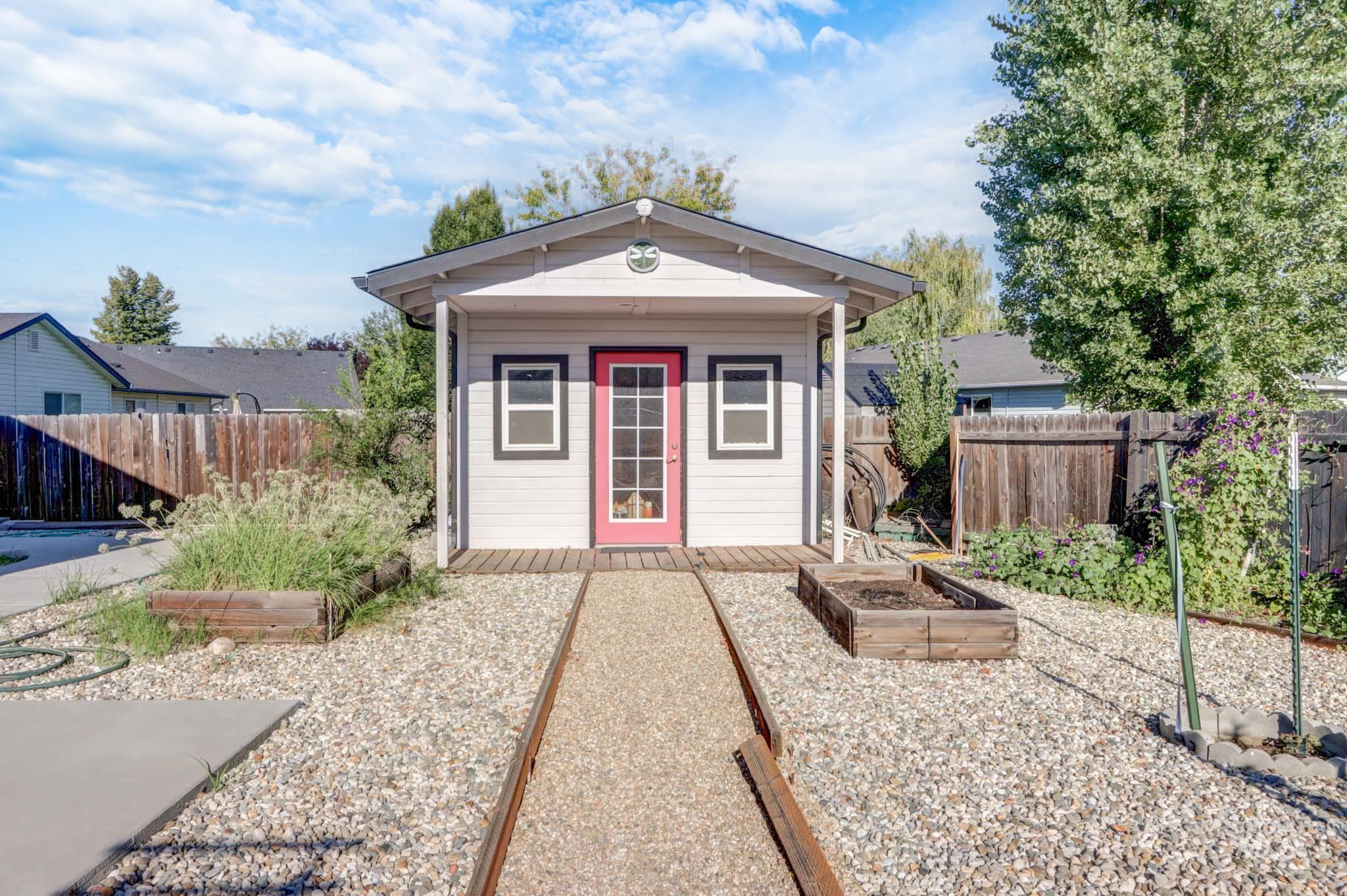 View of outdoor structure with a vegetable garden and a fenced backyard