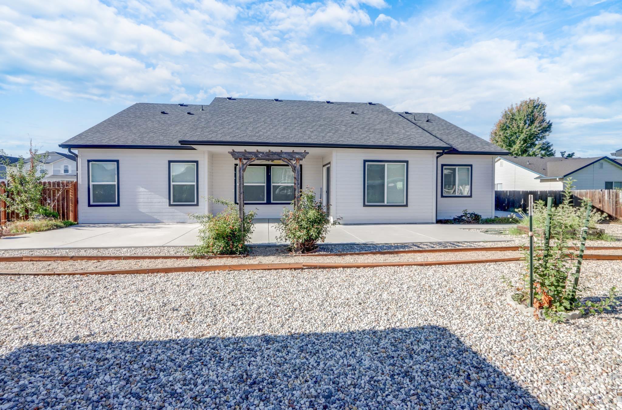 Back of house with a patio, roof with shingles, and a pergola