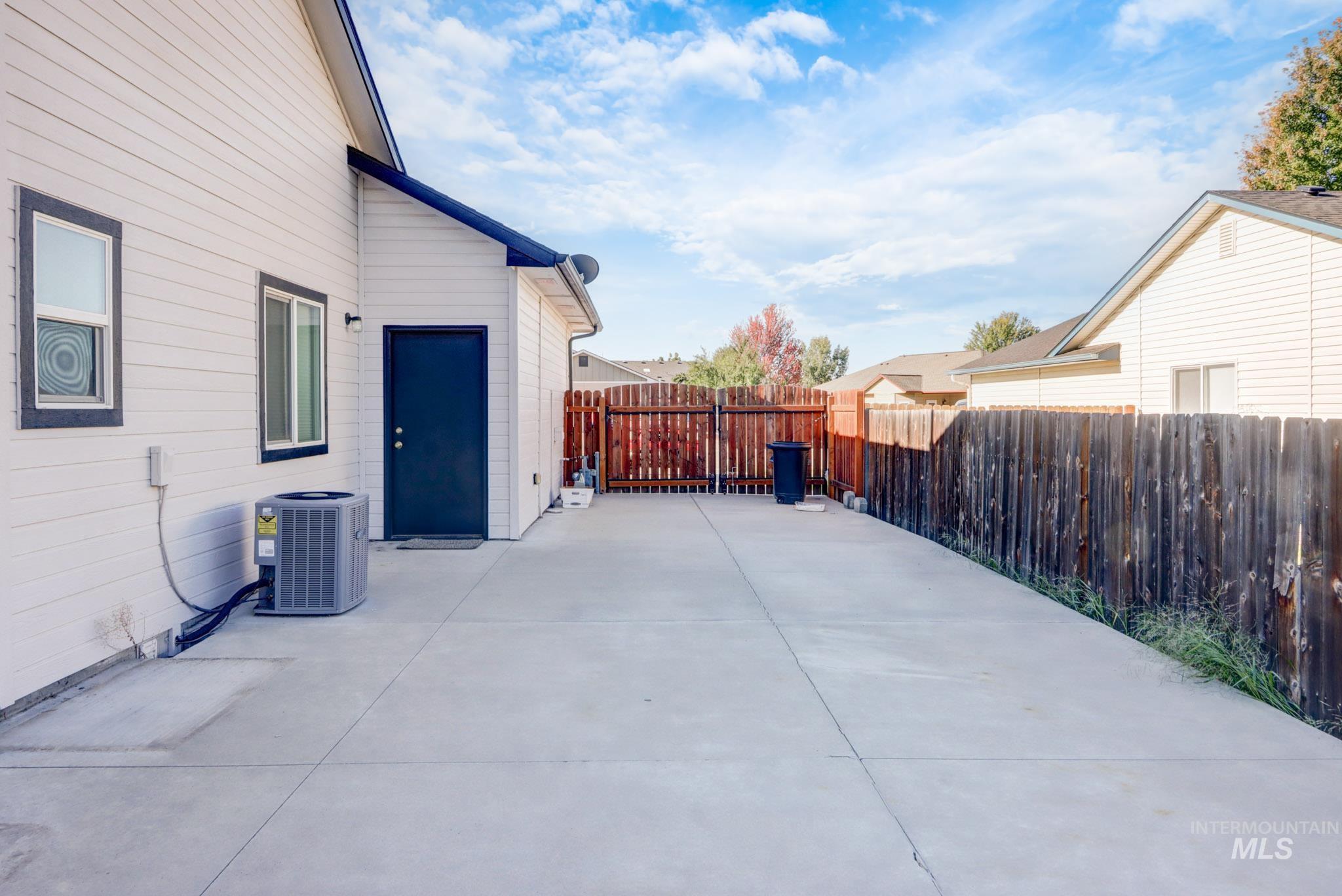 Fenced backyard with a patio area