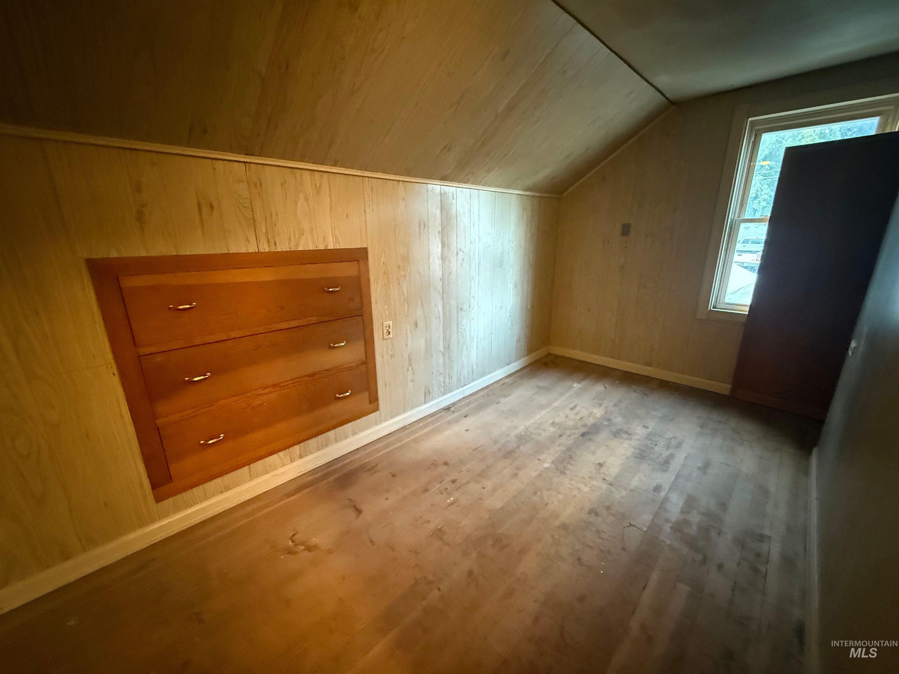 Bonus room featuring wood walls, wood finished floors, lofted ceiling, and wood ceiling