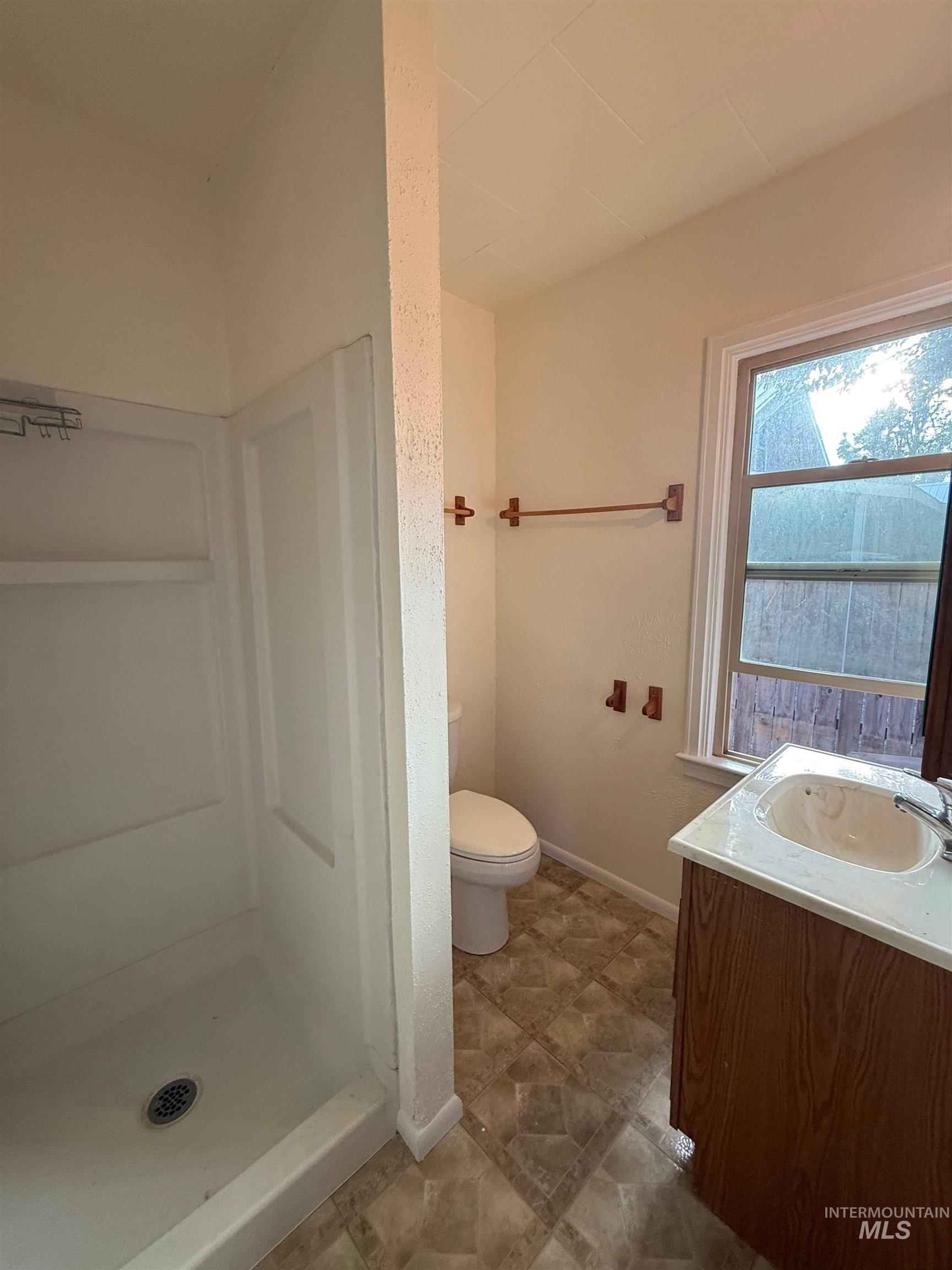 Full bath featuring vanity and a shower stall