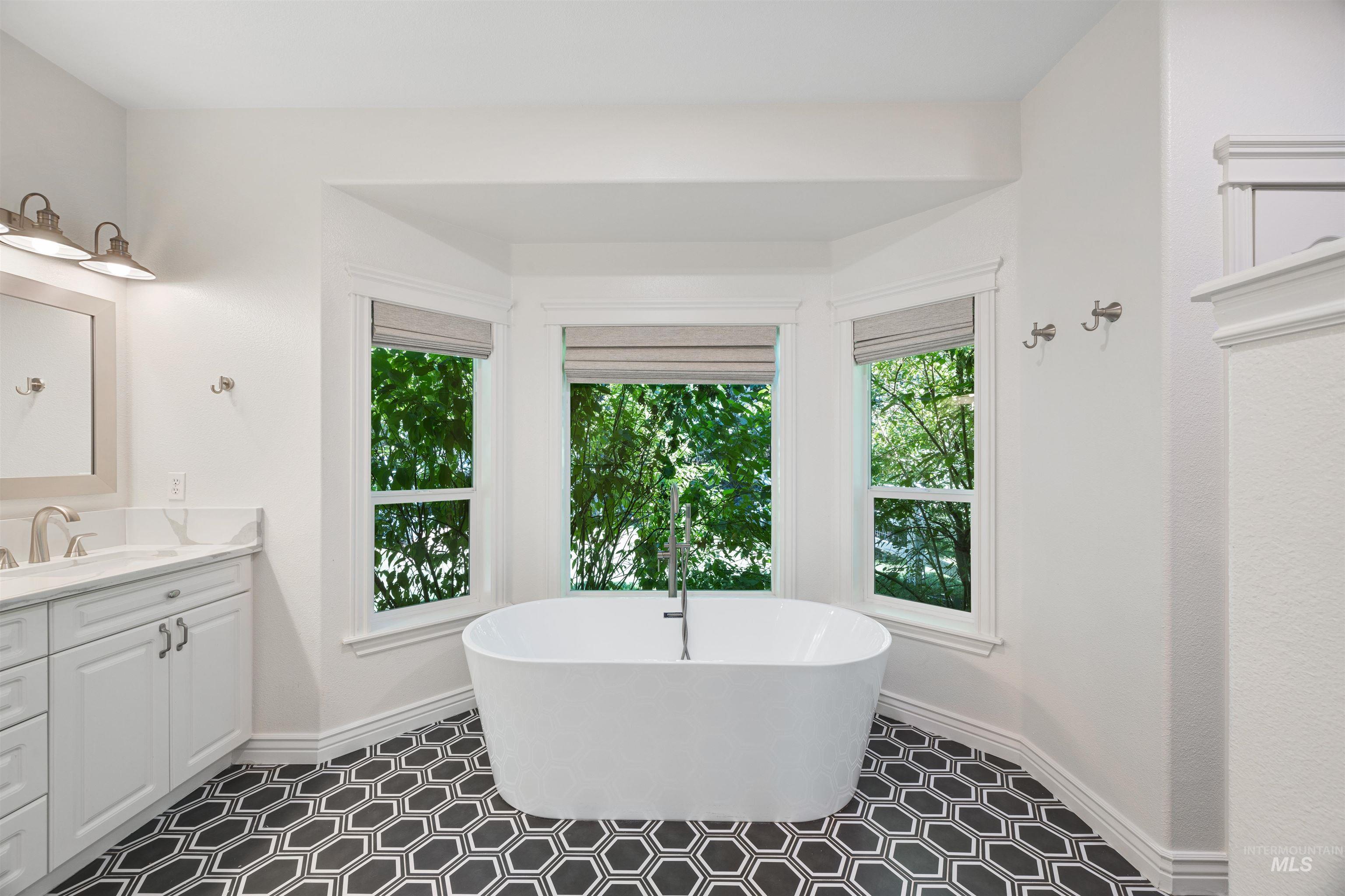 Full bathroom featuring a freestanding tub and vanity