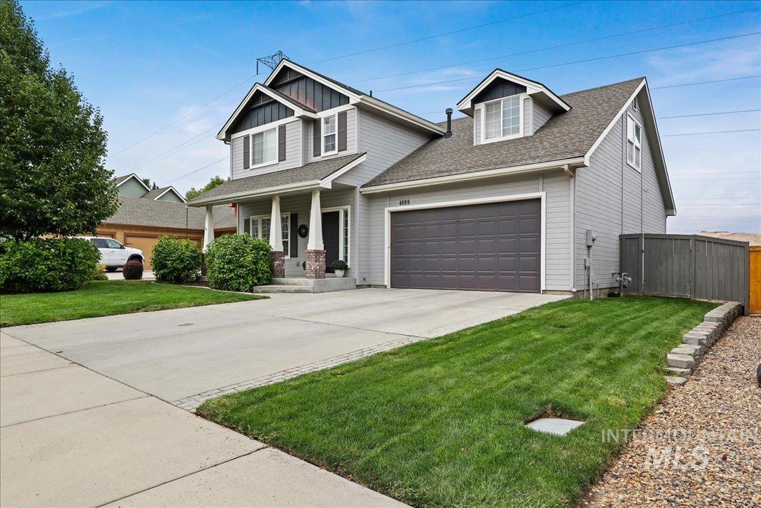 Craftsman inspired home with covered porch, driveway, roof with shingles, a garage, and board and batten siding