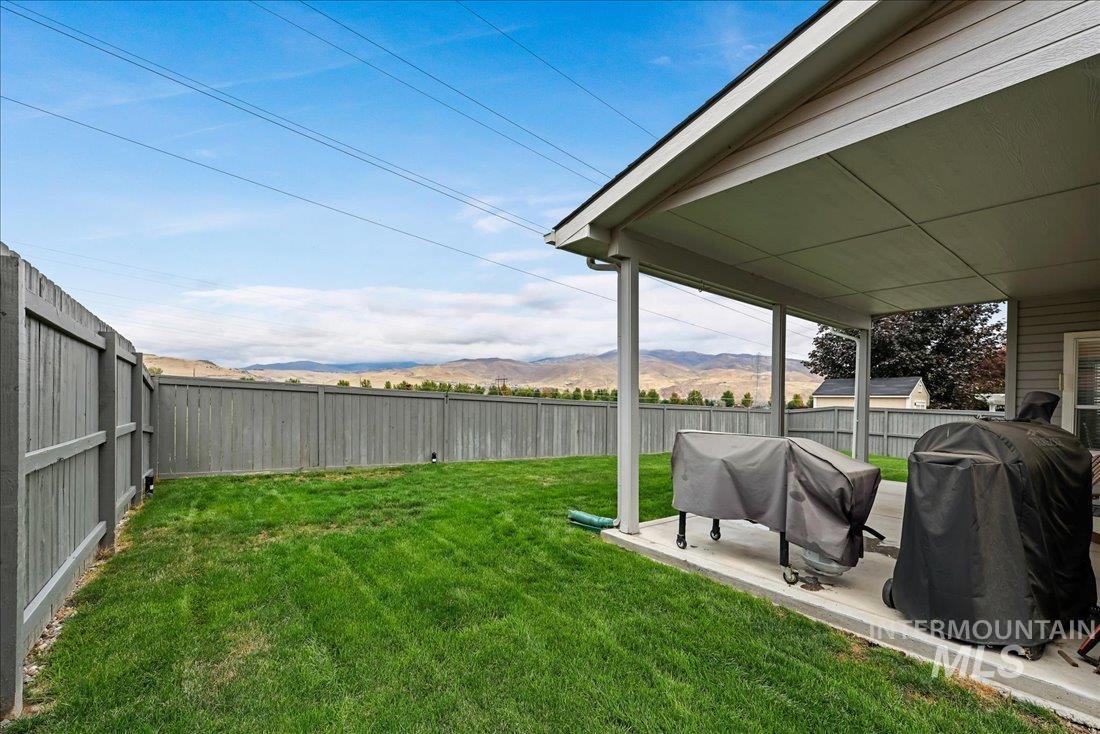 Fenced backyard with a patio and a mountain view