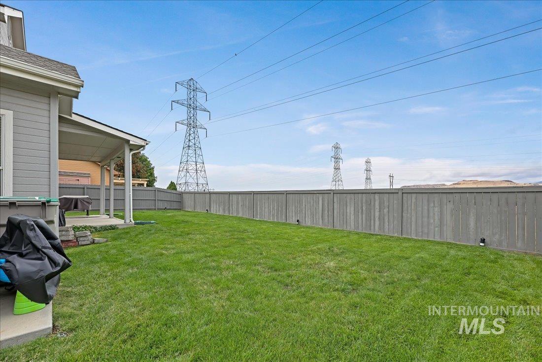Fenced backyard with a patio