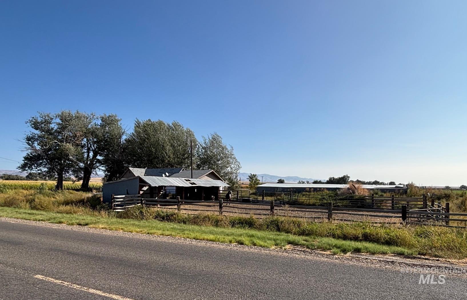 View of front of home with a view of rural / pastoral area and a mountain view