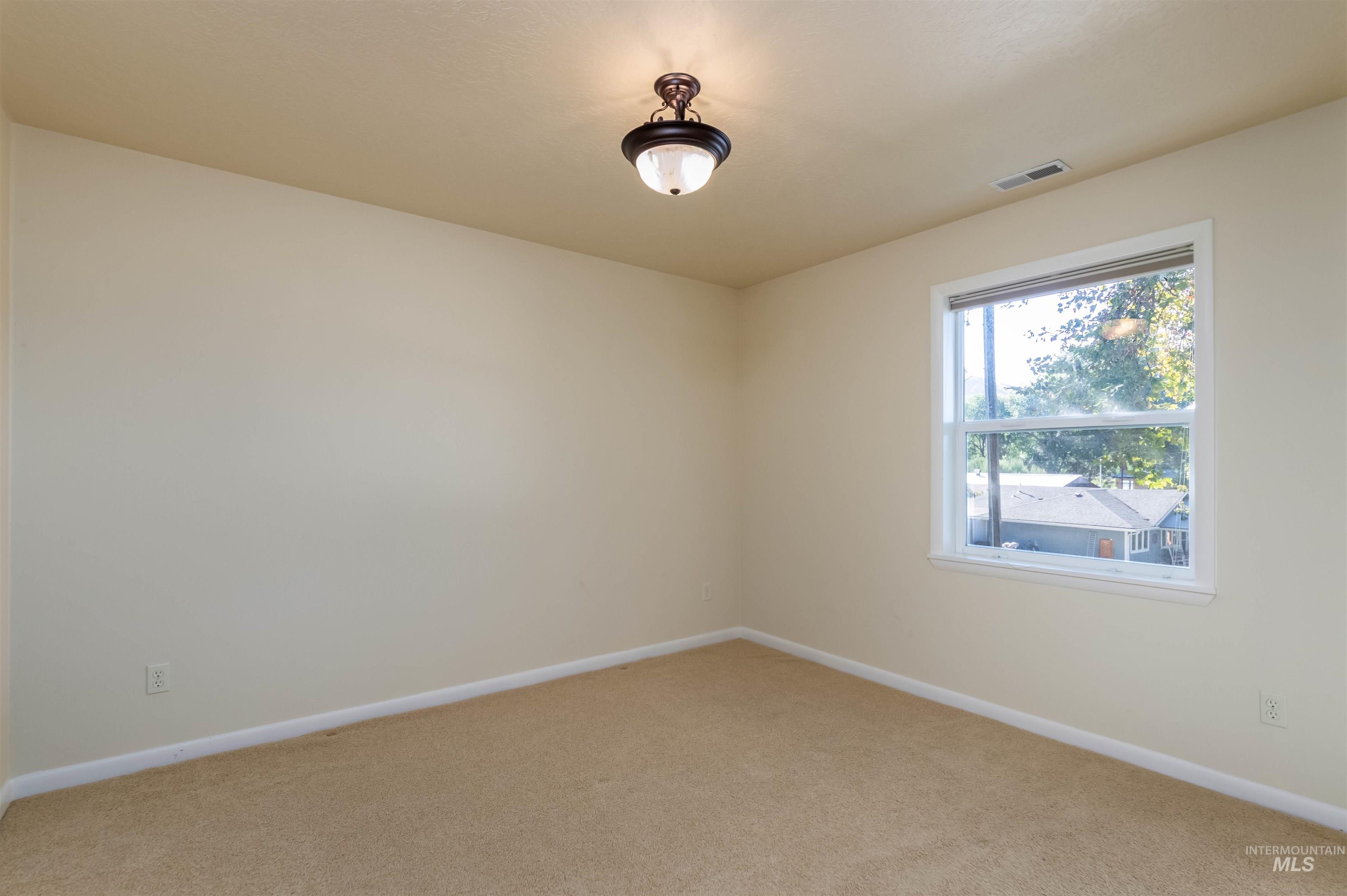 Bedroom with baseboards and carpet