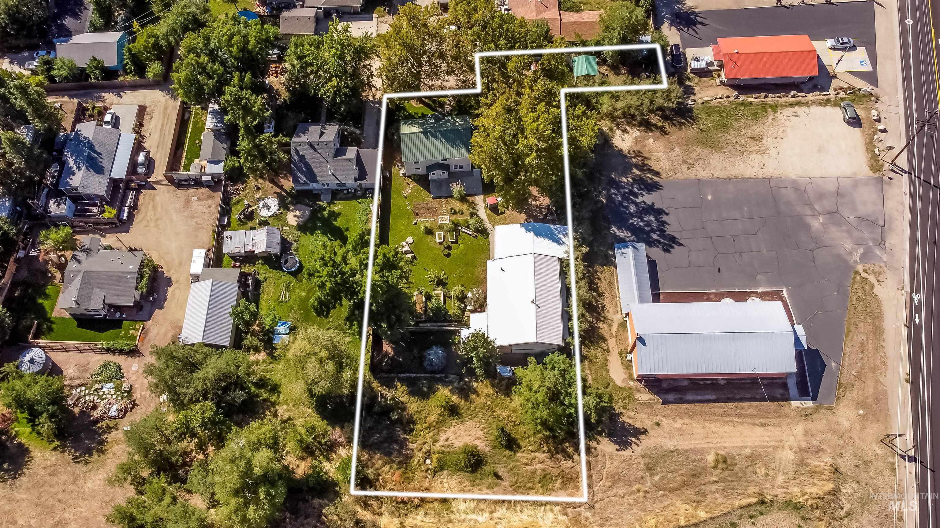 Aerial view of residential area with property parcel outlined