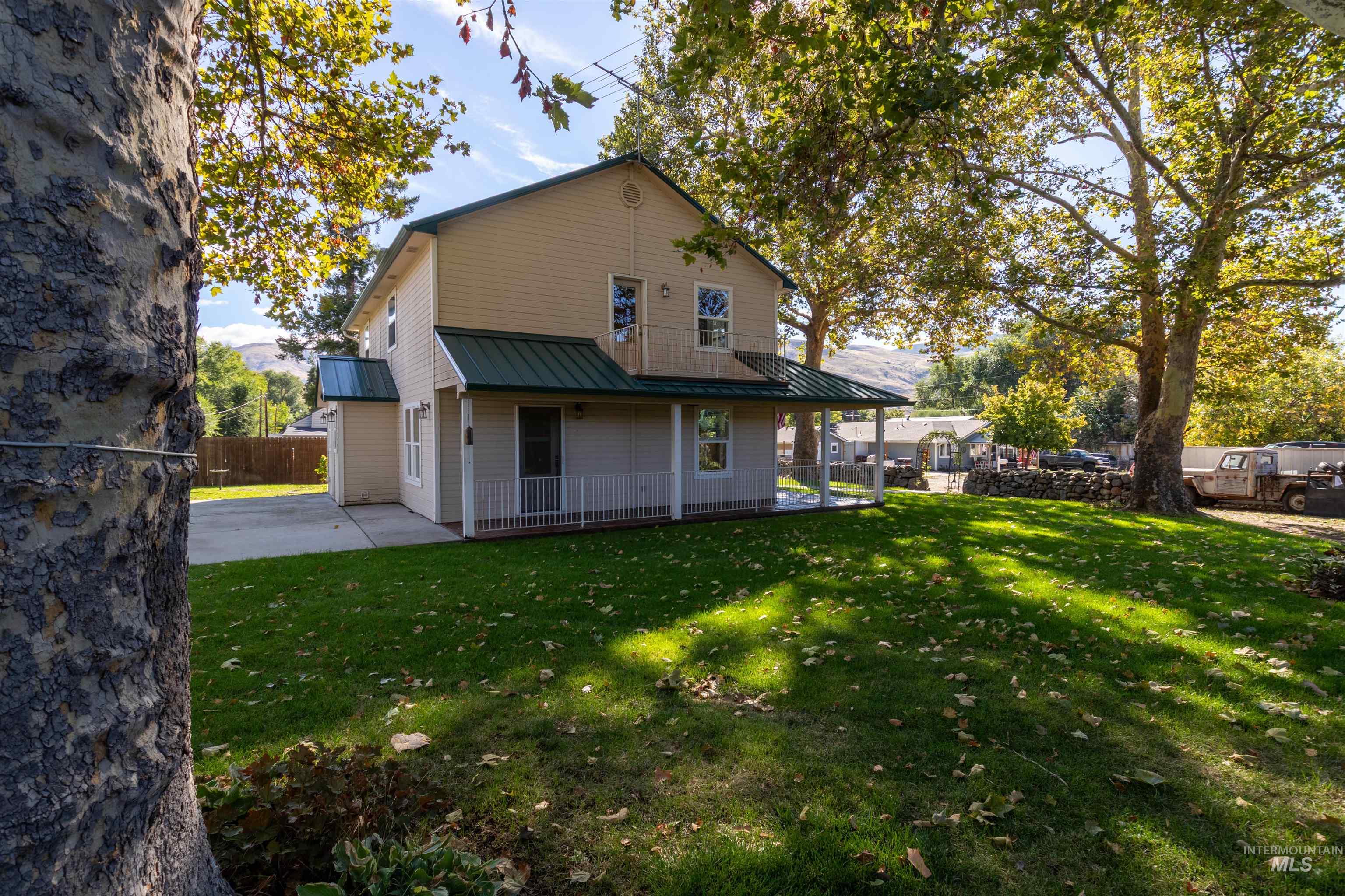 Back of house featuring a metal roof and a patio