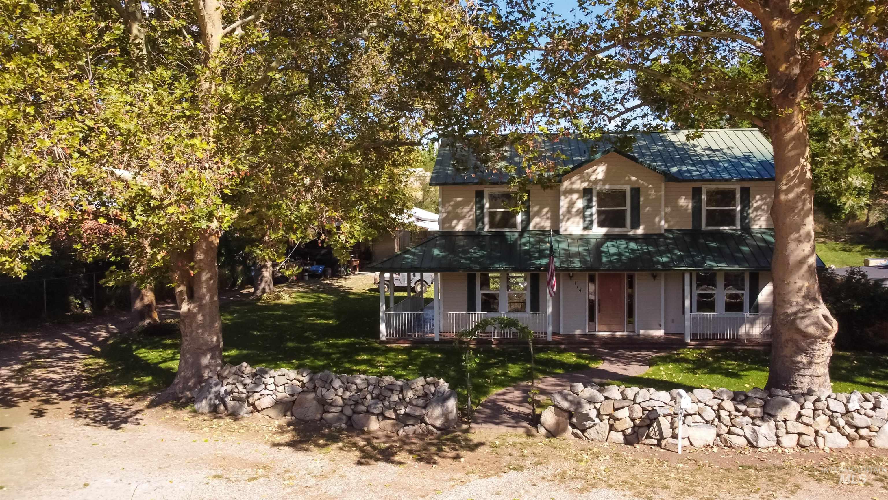 Country-style home with a porch and a front yard