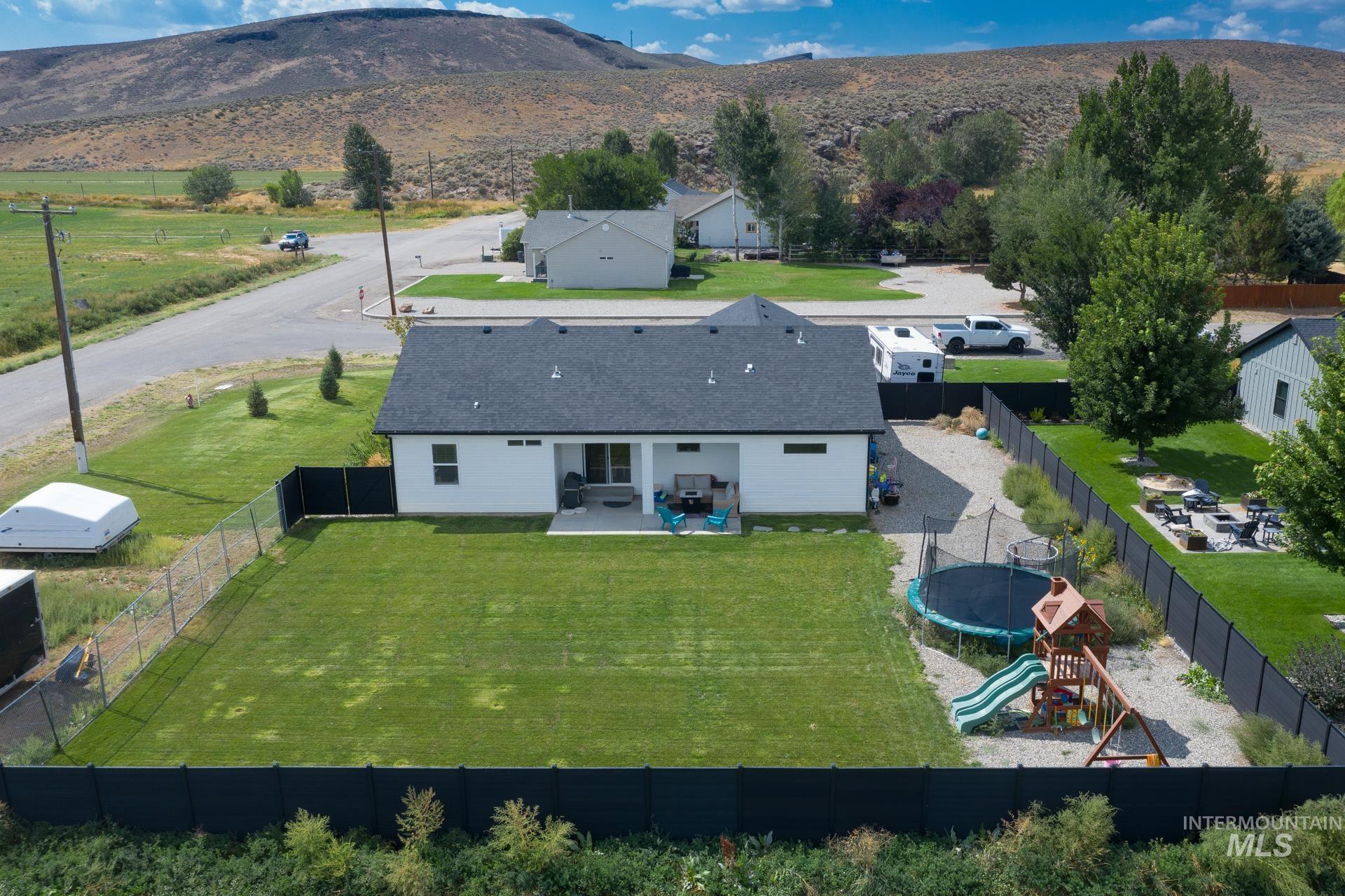 Aerial view of property and surrounding area featuring mountains