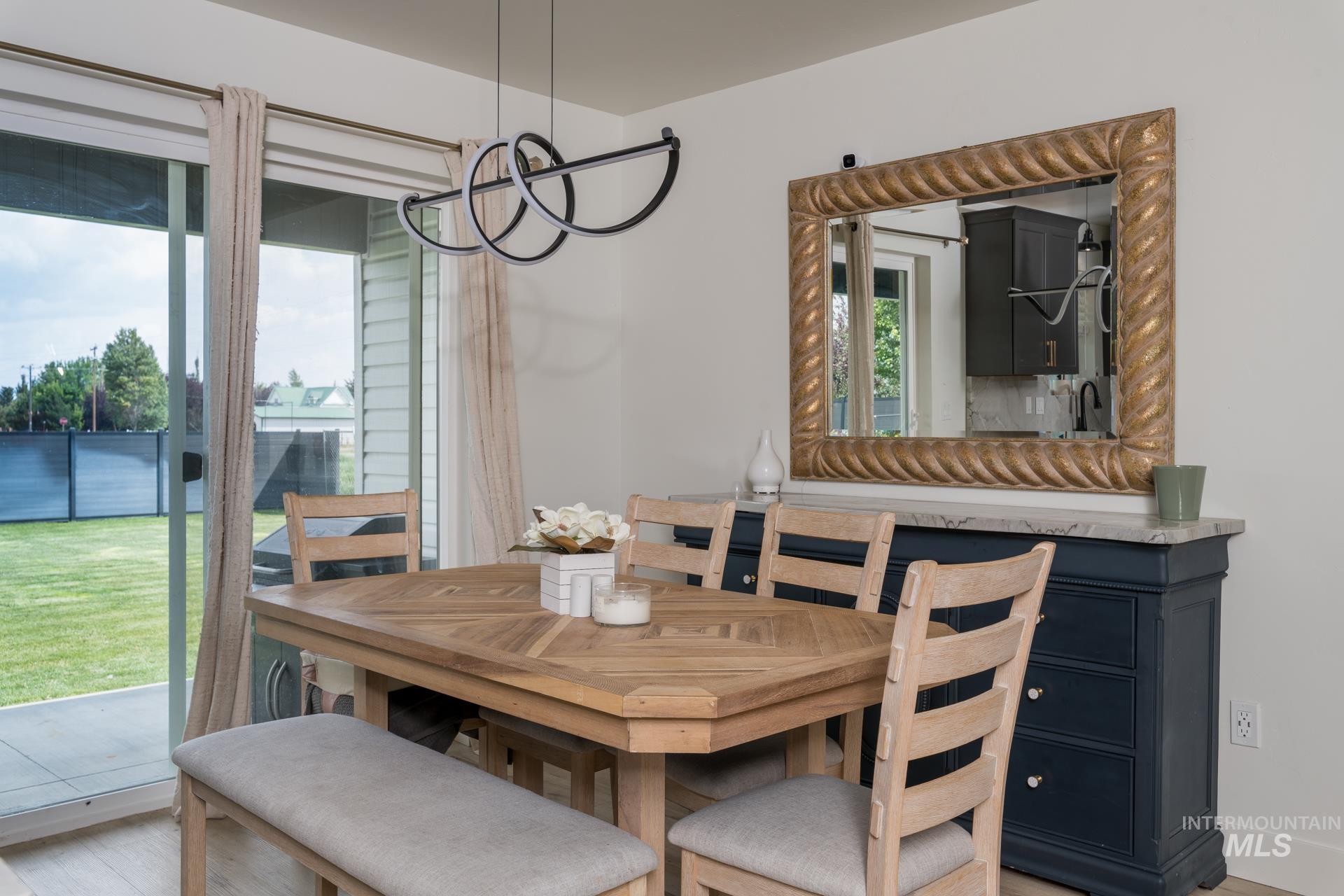 Dining space featuring a chandelier and light wood finished floors