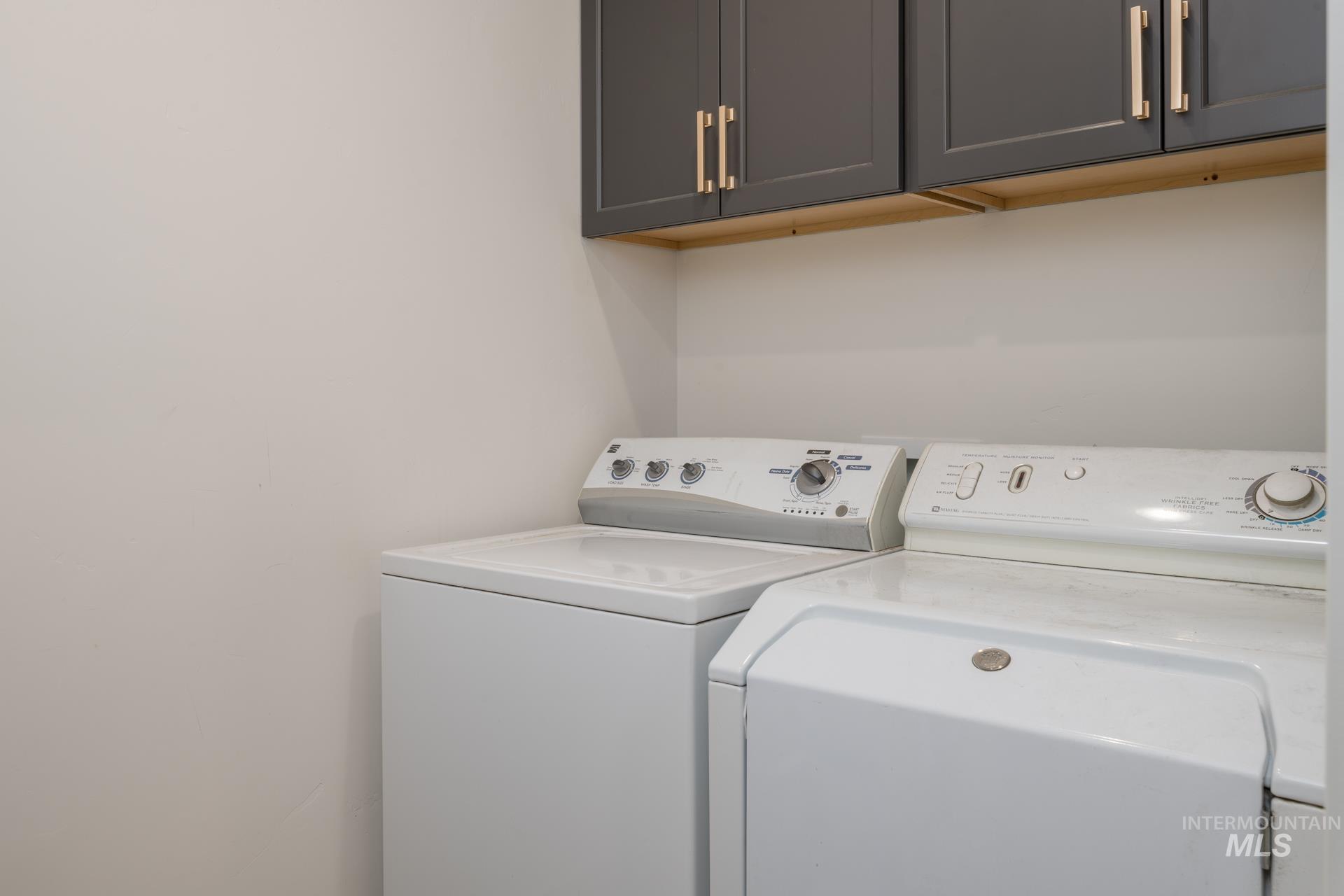 Laundry area featuring cabinet space and washing machine and clothes dryer
