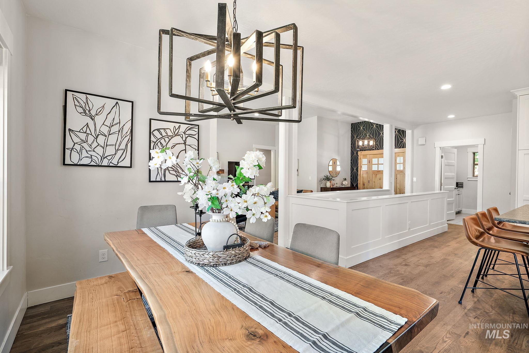 Dining room with dark wood finished floors, a chandelier, and recessed lighting