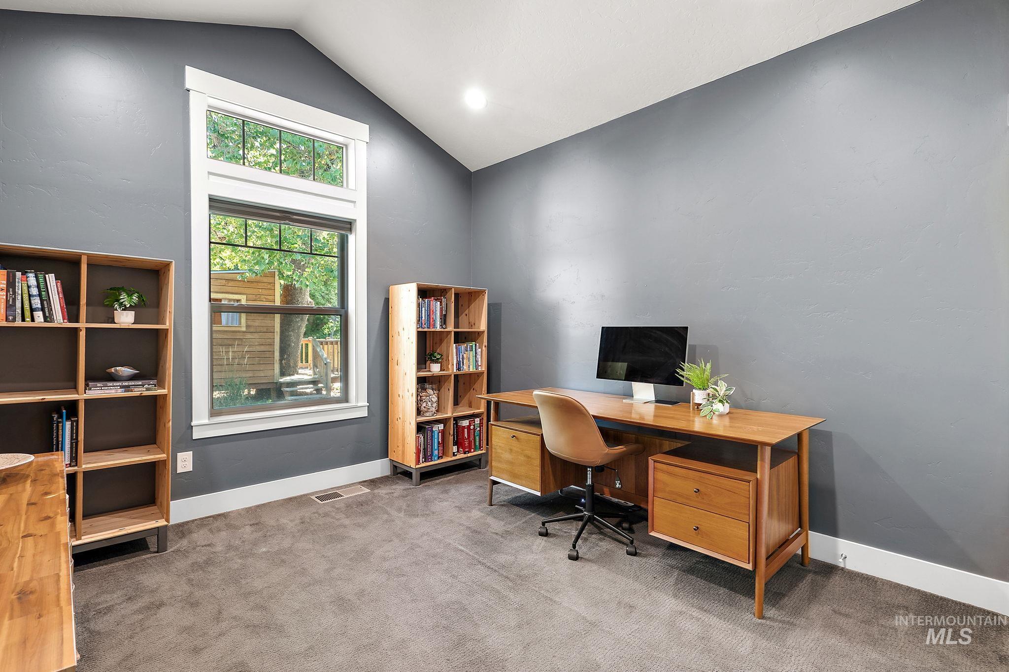 Office featuring carpet flooring and lofted ceiling