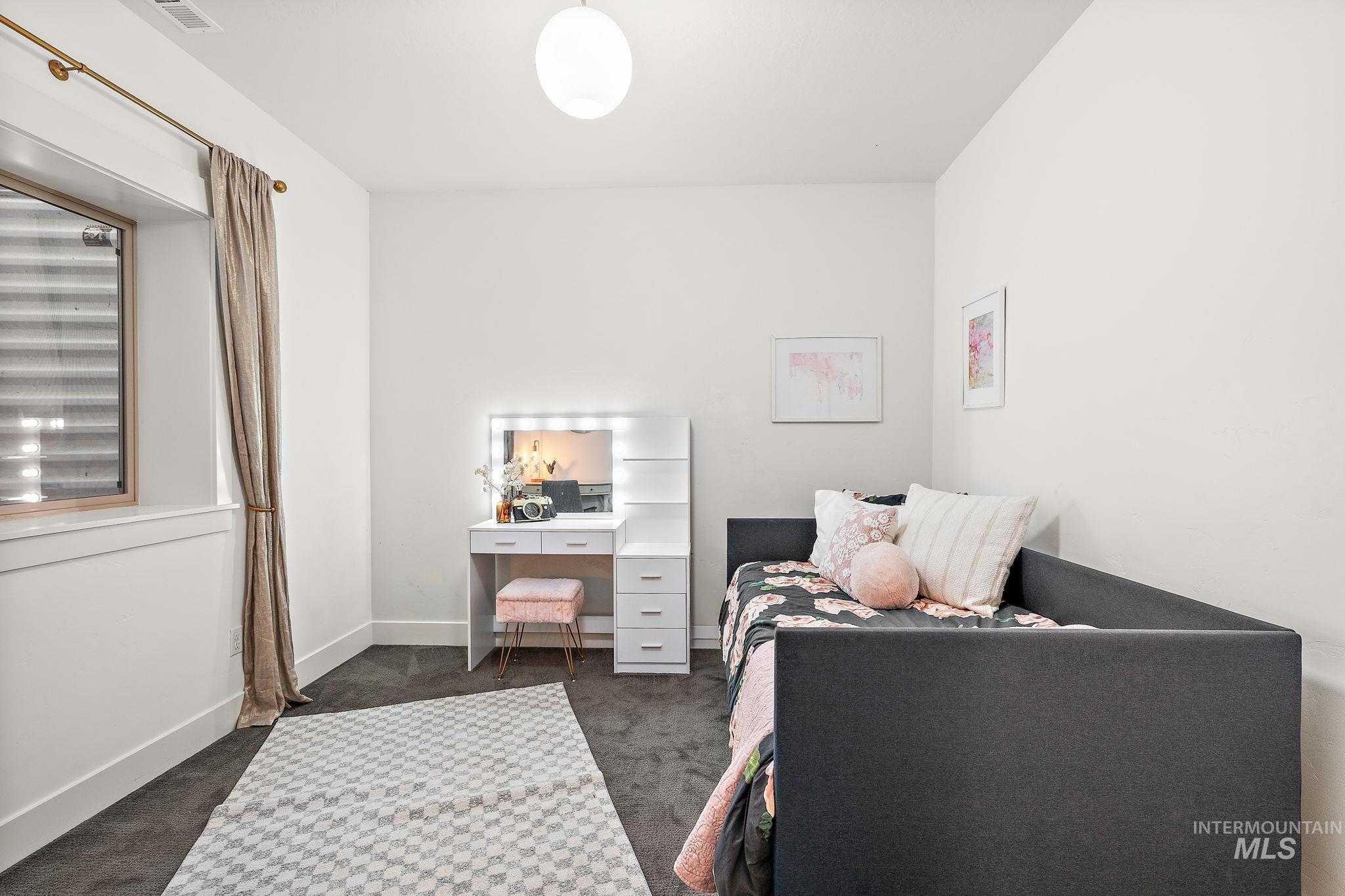 Bedroom featuring dark colored carpet