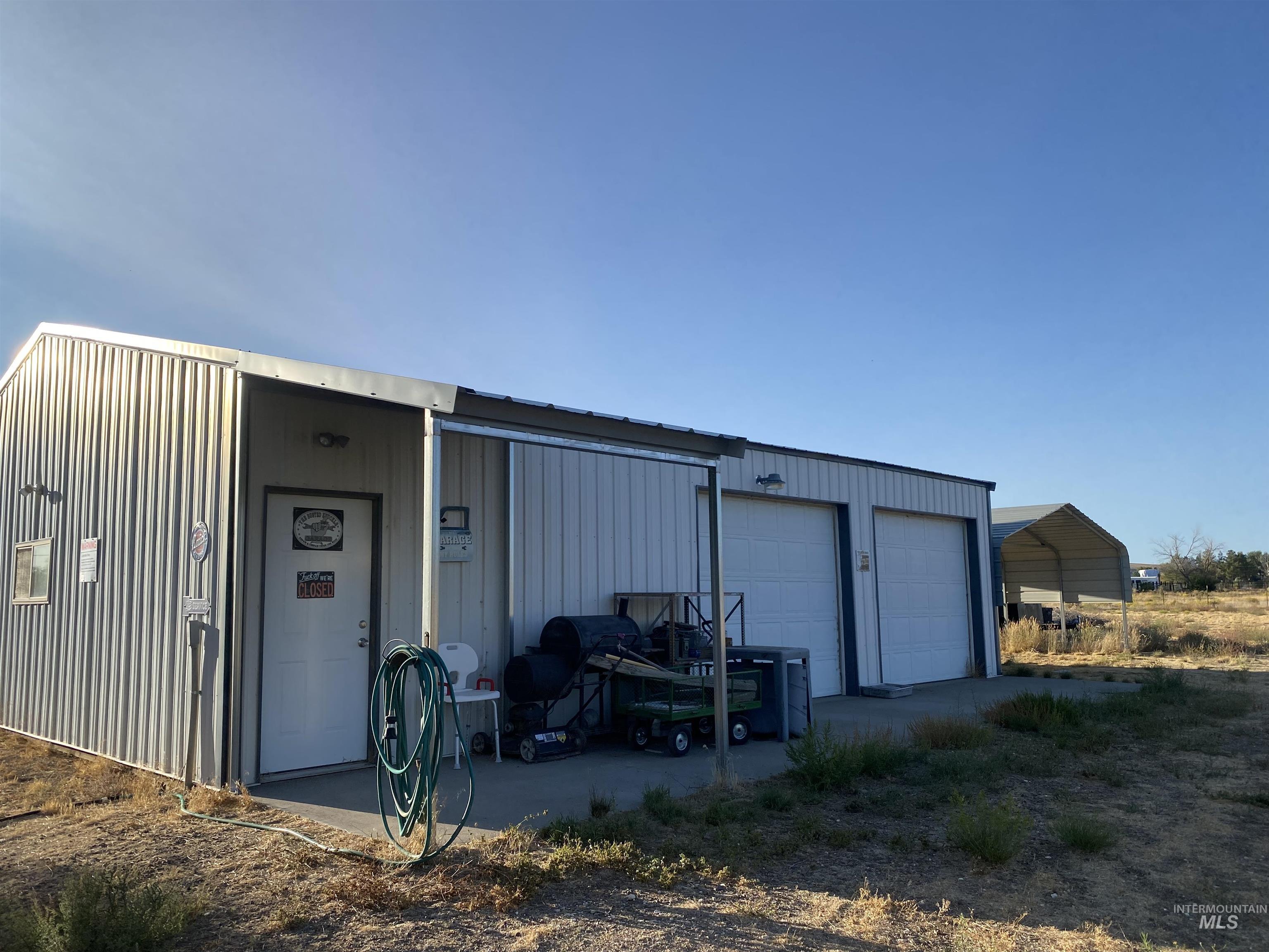 Detached garage featuring a carport