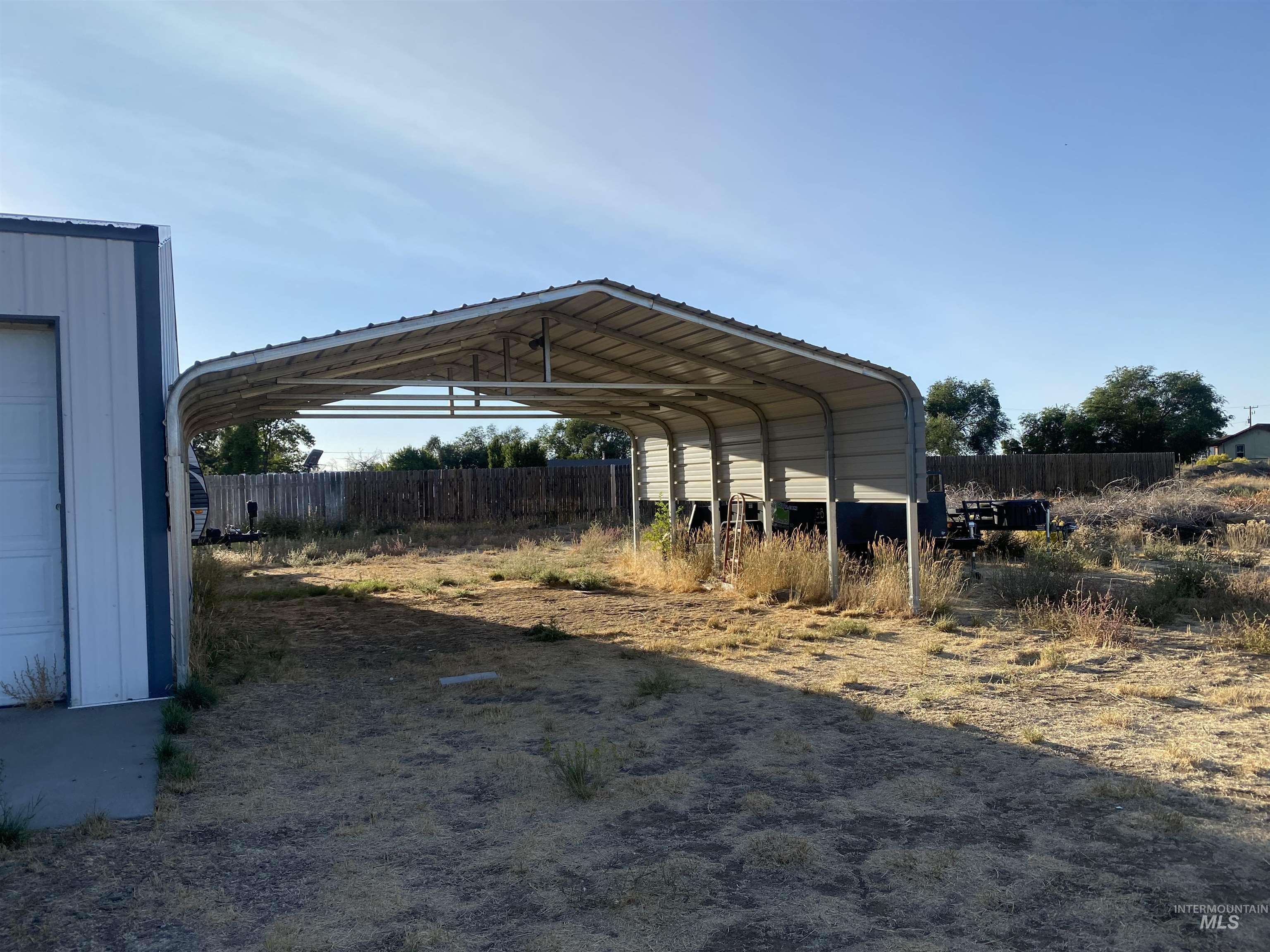 View of vehicle parking featuring a detached carport