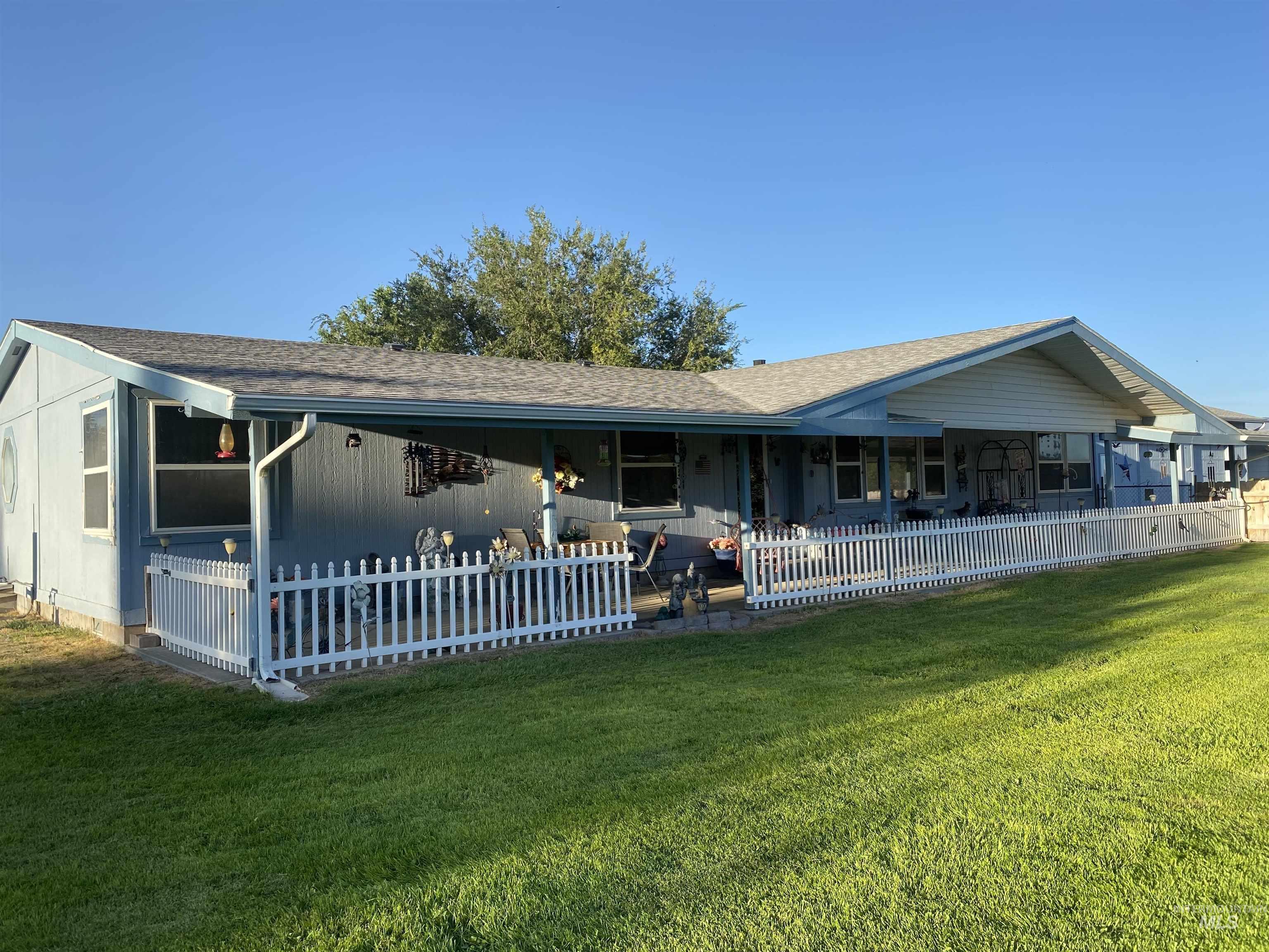 View of front of house featuring a shingled roof and a patio area