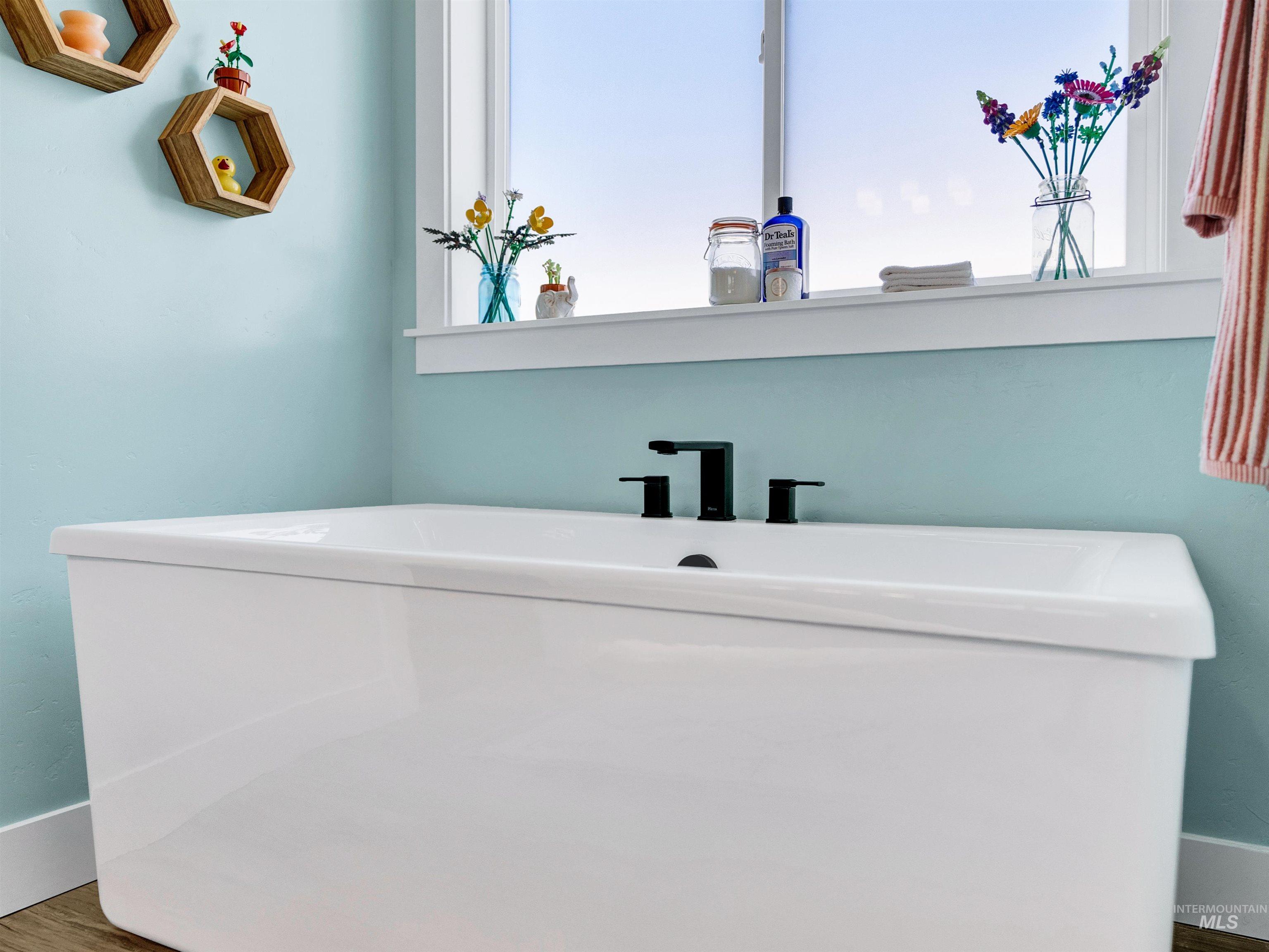 Bathroom with wood finished floors and baseboards